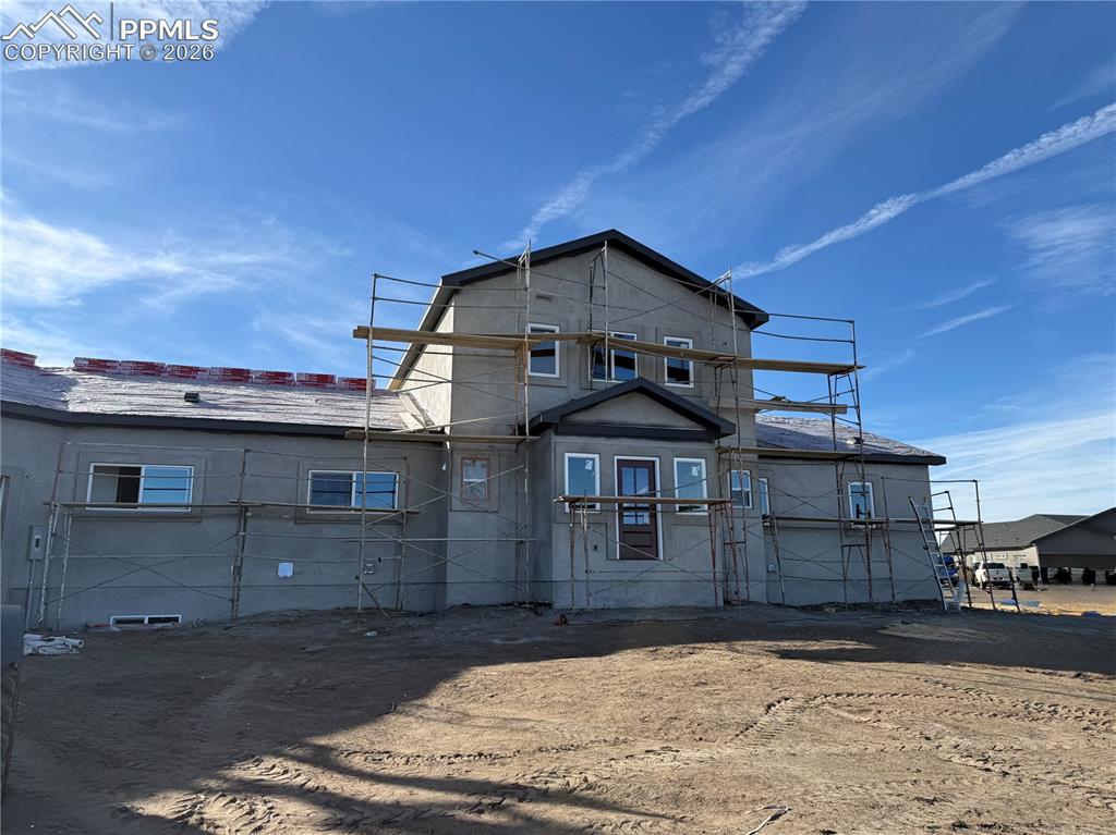 This exceptional new construction home in Wyoming Estates offers the perfect balance of wide-open country living withoutfeeling remote, set on 5.41 acres with breathtaking 360-degree views including sweeping mountain and Pikes Peak vistas.With land surrounding the home, privacy is abundant. This thoughtfully designed 1.5-story home features nearly 3,900square feet of finished living space with an open-concept great room showcasing vaulted ceilings, a gas fireplace, andexpansive windows that frame the incredible scenery. The gourmet kitchen includes granite countertops, a large island,walk-in pantry, and flows seamlessly into the dining area, making it ideal for everyday living and entertaining. Step outsideto the deck or walk-out patio and enjoy unforgettable sunrises and sunsets from multiple outdoor living spaces. The main-level primary suite offers a private retreat with walk-out access, a spacious walk-in closet, and a luxurious five-piece bathfeaturing a double vanity, soaking tub, and separate shower. The finished walk-out basement expands the living space witha massive family room, wet bar, four additional bedrooms, and two full bathrooms. A loft adds even more usable space for ahome office or secondary lounge. Additional highlights include a three-car oversized attached garage with 9 ft garage doors, 20X40 Barn, RV parking, Two Laundry rooms - one on the main level and one on the basement level. Easy access to Woodmen, Falcon, and the Powers corridor.Conveniently located near Schriever and Peterson Space Force Bases, this property offers panoramic views, space tobreathe, and modern comfort — all in one remarkable setting.