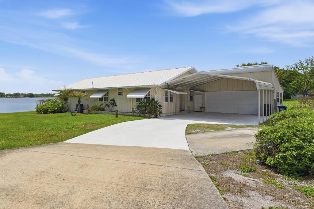 Experience the pinnacle of “True Florida” lakefront living at this exceptional Lake Echo estate! Tucked away at the end of a quiet cul-de-sac in the charming town of Lake Alfred, this meticulously maintained 3-bedroom, 2.5-bath home sits on a beautifully manicured 0.37-acre lot with 110 feet of pristine lake frontage and breathtaking sunrise views—all with NO HOA.Built in 2005 with durability and peace of mind in mind, the home showcases a metal roof and specialized steel/metal framing for long-term structural integrity. Inside, you’ll find an expansive open floor plan with soaring 15-foot vaulted ceilings, abundant natural light, and elegant finishes throughout. Entertain effortlessly with a wet bar and an abundance of cabinetry providing both style and functionality.The primary suite is a true wellness retreat, featuring a private in-bedroom sauna, a luxurious hydro massage walk-in spa tub, separate shower, and refined details designed for relaxation and comfort.Outdoor living is second to none. Enjoy the rear Florida Room and adjacent screened lanais, including a spacious covered porch with a built-in hot tub spa overlooking the lake—the perfect setting to unwind and take in serene water views. The irrigated and meticulously maintained grounds extend all the way to the lake, creating a lush, resort-style atmosphere.Car enthusiasts and hobbyists will appreciate the oversized double garage filled with natural light, along with additional covered parking options and ample space for storage or projects.Conveniently located just minutes from I-4, this home offers easy access to both Tampa and Orlando while preserving the peaceful charm of small-town living.This is more than a home—it’s your private lakeside sanctuary. Schedule your private showing today and start living the waterfront lifestyle you’ve been dreaming of!