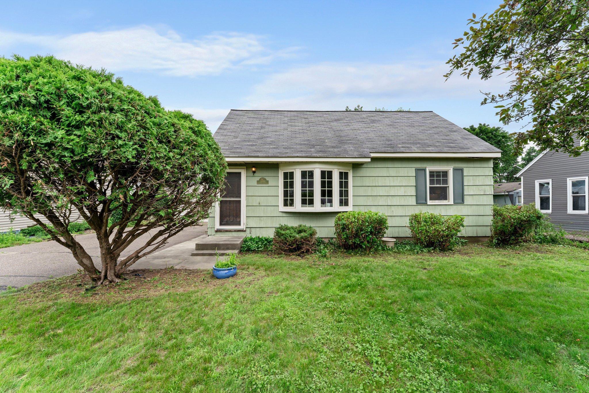 Welcome to this charming story-and-a-half home nestled in a friendly, well-established suburban neighborhood. Step inside to a bright and inviting living room, where large windows bathe the space in natural light. The generously sized kitchen offers ample cabinetry and counter space, with direct access to the back deck—perfect for morning coffee, weekend grilling, or simply enjoying the peaceful, fully fenced backyard. The main level features two comfortable bedrooms and a full bathroom. Upstairs, you'll find a cozy third bedroom and a versatile loft—ideal for a home office, reading nook, creative space, or playroom. The finished lower level provides additional living space with a welcoming family room, perfect for movie nights, game days, or a quiet retreat. A detached one-car garage adds extra convenience and storage. Located just minutes from Twin Lakes, this home offers easy access to parks, trails, and a variety of shops and dining options.