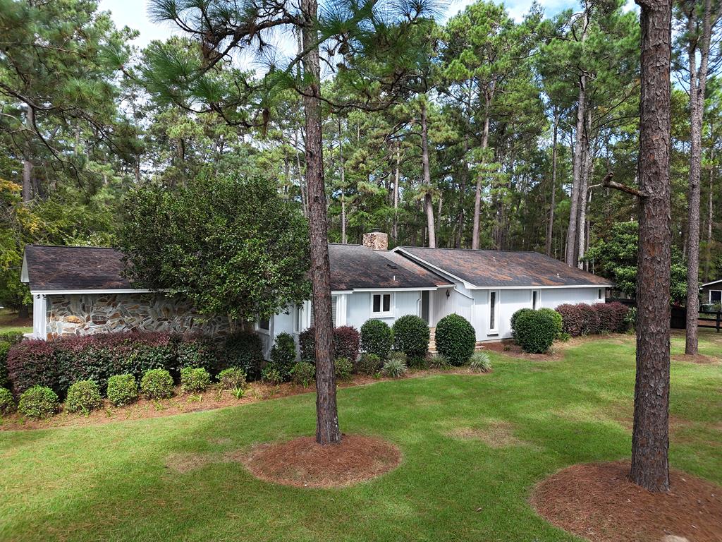 Nestled in the Pines! This is a beautiful 5 bedroom 3 bath home, Over 3200 s.f.. So much to offer in this home,Double doors in the foyer features stone floor, large kitchen with breakfast area, formal dining room, large fireside family room with spectacular stone fireplace-real wood burning. Master bedroom has a large bath with separate shower and garden tub, his and her closets. French doors lead out to a glass sunroom heated and cooled. Outdoors features a wood deck with pool and cooking cabana!  All this in a countryside peaceful landscaped private yard.