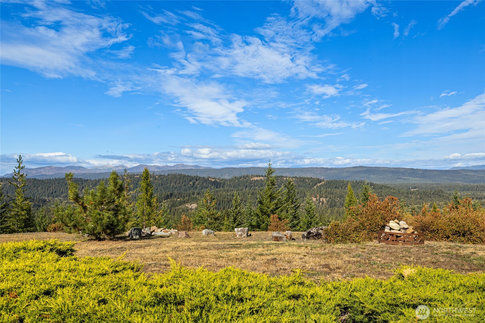 Wide-open views across the valley and surrounding mountain landscape.