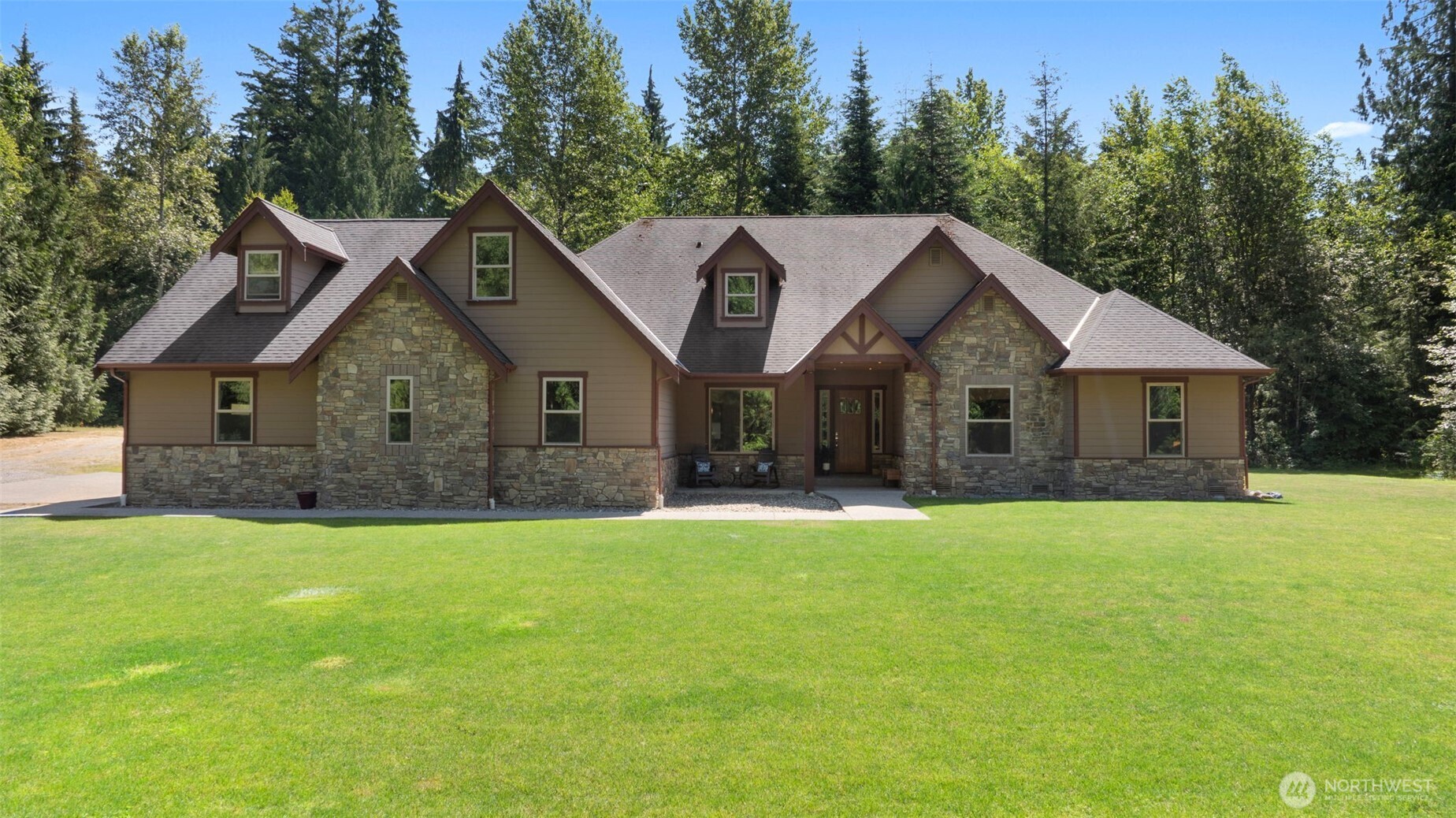 No blinds needed and expectations exceeded on this 5-acre parcel in Arlington, featuring a gorgeous 2012 home with an attached 6-car garage, perfect for collectors, mechanics, or anyone who needs serious workspace. The home itself has NEW luxury vinyl plank flooring, a spacious layout, a formal dining room, abundant storage, and closets. Surrounded by native growth, it feels like living in a park with everything you need on ONE level and the added bonus of EPIC ENTERTAINMENT SPACE UPSTAIRS! Perfect for entertaining or creating your dream hangout. Last but not least, is the BARN, which, with power, plumbing, and MIL potential, will be of particular interest to the aspiring Homesteader. This home has SO MUCH to offer. All just mins from town!