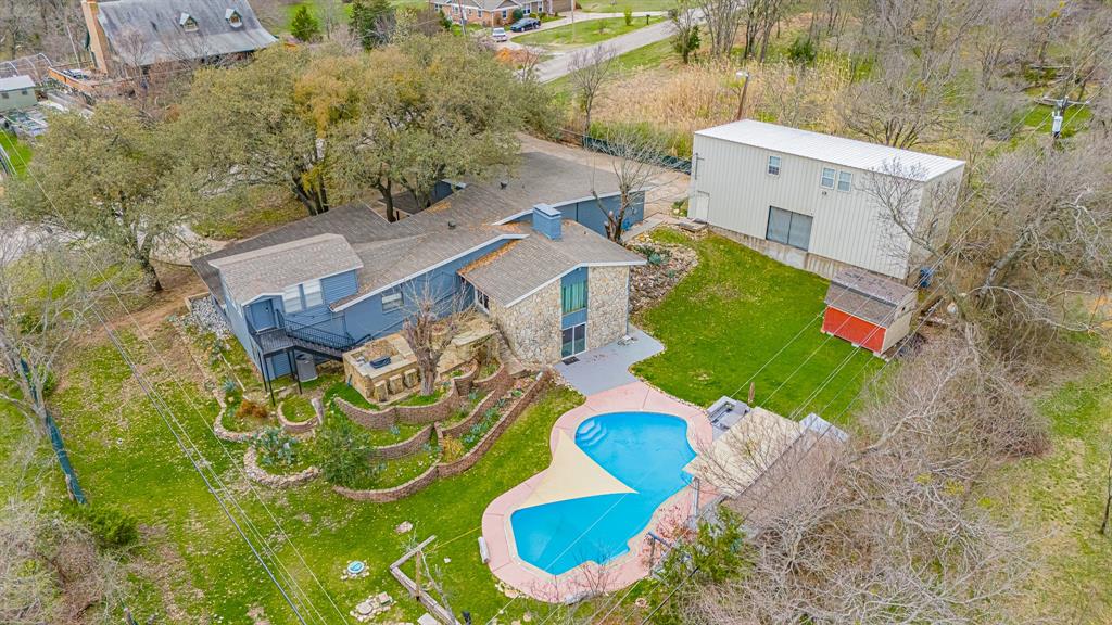 A truly unique opportunity near Benbrook Lake combining privacy, income potential, recreation and an exceptional location in one of Southwest Fort Worth's most exciting growth corridors. Backing up to U.S. Army Corps of Engineers land, this one-of-a-kind property offers the feel of a private retreat while remaining convenient to Fort Worth. The main residence is currently operated as a successful nightly rental offering an attractive opportunity for an owner-occupant, investor or buyer seeking a property with existing income potential. A separate multi-purpose building adds incredible versatility, featuring an indoor shooting range, art studio and a full upstairs apartment ideal for additional rental possibilities or private living quarters. Outdoor living is equally impressive with a private swimming pool, cabana, mature trees and abundant space to relax and entertain. Nearby bike trails provide access to downtown Fort Worth and Benbrook Lake, where boating, recreation and incredible fishing are just minutes away. The location is becoming even more desirable as significant luxury residential and recreational development continues throughout the Southwest corridor. Nearby Maverick Golf & Ranch Club is bringing an approximately 1,100-acre luxury golf and ranch community with Tom Fazio-designed golf, including its Pinkerton 9 par-3 course and planned championship golf. The broader corridor is also seeing major investment through developments including Bluejack Ranch and Kelly Ranch, adding luxury residential, golf and commercial development to this rapidly evolving area. Whether envisioned as a private residence, recreational retreat, multi-generational property or income-producing investment, 5578 Tiger Trail offers a combination that is increasingly difficult to find: privacy, existing rental income, flexible additional living space, a pool, proximity to Benbrook Lake and trails, and easy access to the area's tremendous the growth.