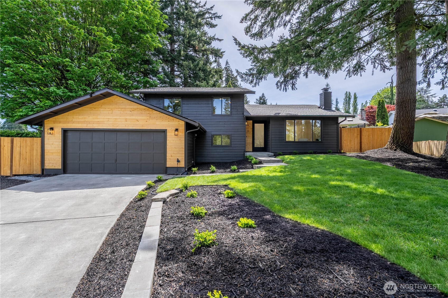 Stylish, fully updated tri-level in Bothell near Canyon Park! The bright main floor features an open layout, a modern wood-burning fireplace, and a stunning kitchen with quartz counters, a large island, and new appliances. An oversized slider fills the dining area with natural light and opens to the patio. Upstairs: three bedrooms, including a spacious primary suite with private en suite and deck access. Downstairs offers a 4th bedroom or office, a large rec room with an electric fireplace and beautiful accent wall, ¾ bath, and laundry/utility room. The two-car garage, shed with electricity, and backyard storage shed offer room for all your hobbies on the 8,712 sq ft lot. Tucked into a quiet neighborhood close to Northshore schools & parks.