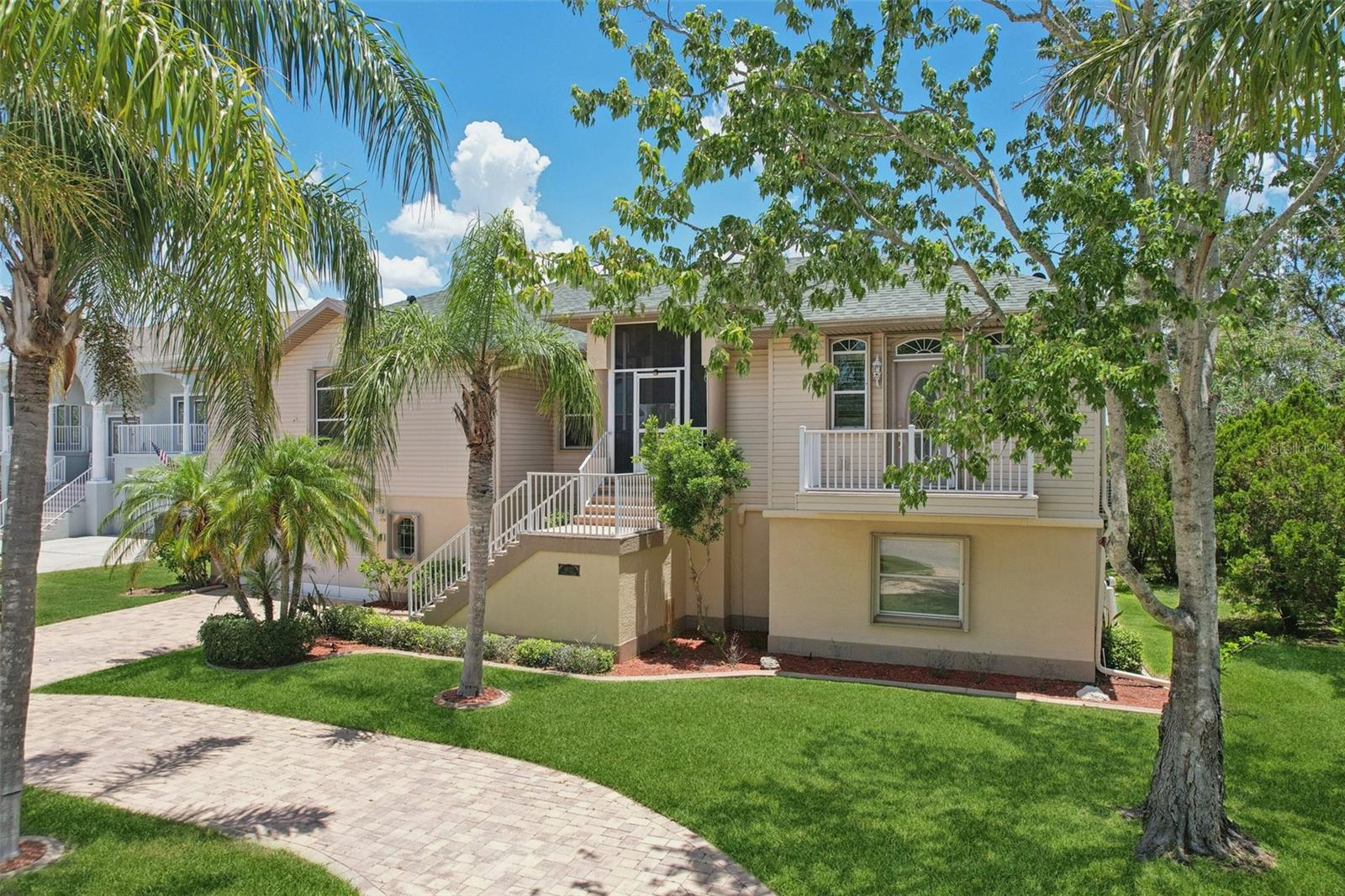 Elegant Coastal Sanctuary with Expansive Living Space. Welcome to this distinguished residence in Gulf Harbors Woodlands, where luxury and comfort converge in spectacular fashion. This immaculately maintained three-bedroom, two-bathroom home encompasses a generous 2,773 square feet of thoughtfully designed living space, with an additional 1,760 square feet on the first floor complete with a full bar and offering versatile possibilities for a Billiard room, creative studio, movie studio or professional office- a true entertainment haven. The construction quality is immediately apparent upon entering, with soaring ceilings creating an atmosphere of grandeur and spaciousness. Recently refreshed with a pristine interior paint palette, this residence showcases meticulous attention to detail throughout. The heart of the home features a chef-inspired kitchen appointed with sleek stainless steel appliances and loads of counter space that overlooks an inviting great room—perfect for intimate gatherings hosted around the fire. The formal dining room features custom built-ins, a stunning chandelier and an adjoining sitting room, perfect for after dinner drinks and conversation. The sumptuous primary bedroom offers a private retreat with direct access to a screened balcony, where one can savor morning coffee while overlooking the tranquil pool and landscaped grounds. Two more comfortable bedrooms are separated for full privacy, complete the main floor living space.
This residence offers uncommon luxuries including an elevator, central vacuum system,generator hookup, and a dedicated cosmetology station in the spacious laundry room—don’t need a hair station? Add your own luxury dog spa instead! Outdoor enthusiasts will appreciate the thoughtfully designed exterior spaces, including a circular driveway providing ample parking and impressive curb appeal. Remote controlled Hurricane shutters offer peace of mind, and convenience during inclement weather, while recent upgrades including a 2021 roof replacement and 2018 air conditioning system ensure worry-free ownership. Automotive enthusiasts will appreciate the remarkable five-car garage with an adjoining workshop area, perfect for tinkering with weekend projects or storing your collection of vehicles. For the environmentally conscious, an electric vehicle charging station awaits your Tesla, Rivian, or other electrified chariot. The community enhances your lifestyle with exclusive amenities including a private yacht club with marina and restaurant, boat ramp, tennis courts, and community pool. Gulf Harbors residents enjoy exclusive privileges unavailable anywhere else in Florida for only $200 per year you receive deeded access to the community's PRIVATE GATED WHITE SAND BEACH with abundant Cabana’s that house BBQ grills and picnic tables, where corn-hole and volleyball tournaments connect you with community and nature. Two community boat ramps, and a vibrant voluntary civic association offering abundant clubs, activities, and social gatherings at the welcoming clubhouse are all included for only $100 annually. All of this in a charming golf cart community located less than 2 miles to downtown New Port Richey with fine dining, local shopping, entertainment and Sims park on the riverfront. This isn't just a home; it's a statement of discerning taste. Call now for your private showing.