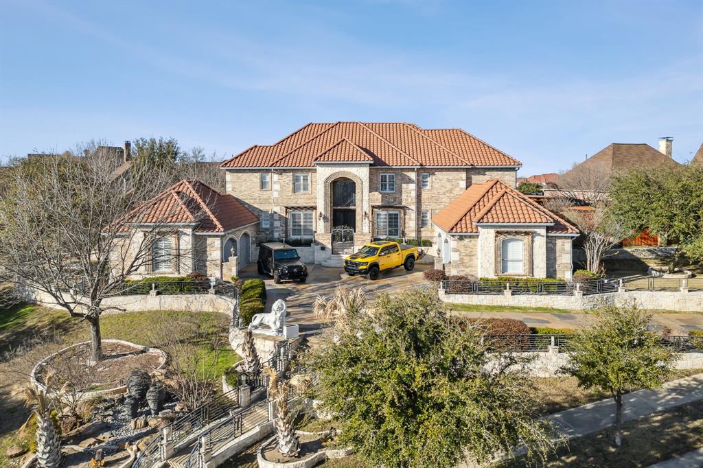 This exceptional estate in Castle Hills Golf and Country Club is a true gem, blending luxury and functionality in a way that's perfect for both relaxing and entertaining.The impressive architecture begins with grand 10-foot wrought iron doors, leading you into an expansive interior that prioritizes both aesthetic appeal and practical design.With 5 bedrooms spread across over 5,100sf, this home includes dual staircases and 3 spacious living areas that create an open and inviting atmosphere. For ultimate convenience, the home offers 2 laundry rooms—one on each floor. Additionally, the third car garage can effortlessly transition from vehicle storage to a dedicated workout space, complete with its own private half bath. Entertainment is at the forefront of this home’s design, with a first-floor media room perfect for movie nights and a second-floor game room equipped with a wet bar for a complete entertainment experience. Wine lovers will love the temperature-controlled wine cellar, complete with custom cabinetry and elegantly designed lighting—ideal for storing your finest selections. Stepping outside, the resort-style backyard serves as a private retreat, with a sparkling pool and spa ready for relaxation.  The custom fire pit, outdoor kitchen, serene pond, pergolas, Japanese garden and extensive hardscaping provide the ultimate outdoor experience. Addl 2-car garage with epoxy flooring and custom cabinetry, ensuring an organized space for all your belongings. Located within a master-planned community that boasts access to parks, trails, and top-rated schools, this home is ideally situated for families looking for community amenities.Moreover, world-class shopping, dining, and entertainment venues are just minutes away at Grandscape, Legacy West, The Star, and the PGA headquarters, making this estate not just a home, but a complete lifestyle. To truly appreciate the unmatched elegance and endless possibilities this property offers, schedule your private tour today.