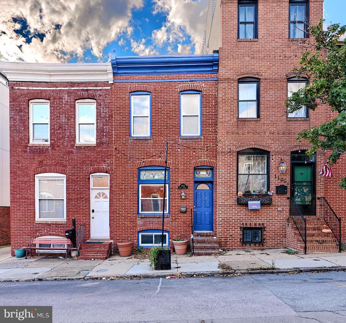 Welcome to 1108 S Baylis Street in the heart of Baltimore’s vibrant Canton neighborhood, this 2-bedroom, 2.5-bath townhome offers PARKING, comfort and style. The spacious open floor plan features hardwood floors, exposed brick accents, and large windows that flood the home with natural light. The sleek kitchen includes all major appliances, tile countertops, and a breakfast bar that opens to the living and dining areas, making it ideal for entertaining.  Walk out the rear to a private deck area with PARKING that has stairs up to a ROOFTOP DECK. The finished basement adds additional living space, perfect for a home office or media room.Situated just steps from Canton Square and the waterfront, this home provides easy access to some of the best restaurants, bars, and shopping Baltimore has to offer. Enjoy leisurely walks along the harbor or a quick commute to downtown via nearby public transportation or major highways. With a private rooftop deck offering stunning city and water views, this home is perfect for those who enjoy outdoor living and entertaining. Ample street parking is available, ensuring convenience in this lively, walkable community.