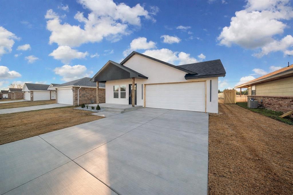 Ready to fall in love with your new home?The builder and preferred lender are offering special incentives for qualified buyers, including a rate buy-down that may significantly reduce monthly mortgage payments, helping you keep more money in your pocket each month. This brand-new North OKC stunner is making homeownership feel exciting & actually attainable. Step inside and you’ll immediately notice the difference. No carpet anywhere, just beautiful tile flooring throughout for a clean, low-maintenance vibe that you have been dreaming about. The open layout flows effortlessly into a show-stopping kitchen with a large island, Frigidaire appliances, premium fixtures, and a separate walk-in pantry (because extra storage really does change everything).The living room is massive and feels open thanks to tall ceilings and a sleek electric fireplace — perfect for movie nights, game days, or hosting friends. The primary suite is your personal retreat, featuring a custom accent wall with built-in sconces and a spa-inspired bathroom with a large tiled walk-in shower, oversized soaking tub, LED mirrors, dual sinks, and a three-tier walk-in closet designed to grow with you.Both bathrooms feature fully tiled showers and elevated finishes, while a dedicated laundry room and a true two-car garage make everyday life easier. Outside, the fun continues with a huge covered back patio with a fully fenced backyard. Plus a covered front porch that’s perfect for morning coffee or winding down at sunset.And let’s talk location. You’re minutes from Topgolf, Chisholm Creek, Costco, Mercy and Kilpatrick hospitals, popular restaurants, shopping, and easy highway access — so whether you’re commuting, meeting friends, or running errands, everything is close by.This isn’t just a house — it’s the start of your homeownership story. Modern, stylish, and packed with upgrades you didn’t think were possible at this price point, this North OKC home is ready to welcome you home.