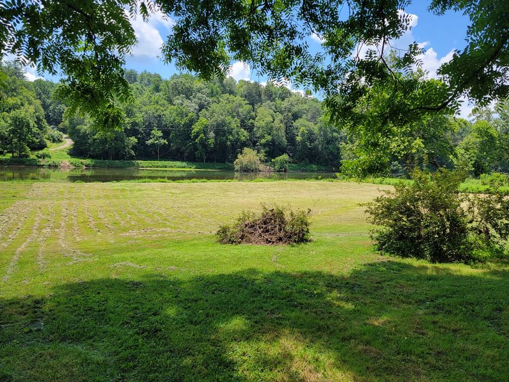 Here it is! Come check out this spacious river lot on the New River. It is nearly flat and offers over 120 feet of river frontage—perfect for summer fun! The property is located just over 1 mile from the public boat landing. Bring your kayaks, tubes, and cooler to enjoy the tranquility of the river. Additionally, this property has certain protective covenants that will help ensure your land is surrounded by well-maintained areas and a peaceful community.