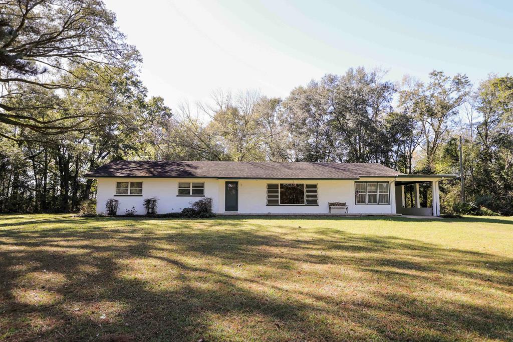 Imagine living in the country & being 5 miles from Thomasville! Over 2+ acres of absolutely beautiful  & private property surrounded in plantation country with wildlife visiting in the backyard on occasion.  Overall well crafted 3 bedroom/1.5 bath home that is built on a concrete slab has potential for renovation & value appreciation. This home has arched doorways, heart pine paneling, charm & storage shed with well house, 1 car carport & an exterior storage room attached to the home. This is that home where you can try your skill at flipping! SELLER CONTRIBUTION OF $25,000 TO HELP WITH CLOSING COSTS OR REDUCE THE SALES PRICE! Need help - I have gotten bids on all of the renovations that I would make & will be happy to share.  You have to see this one to appreciate it!  Call today to schedule your tour!