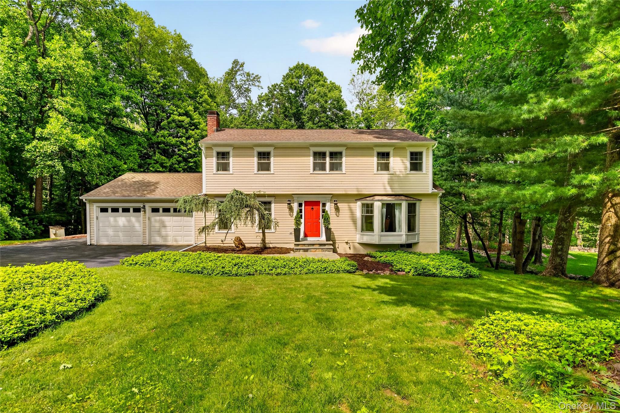 First time available in nearly 20 years, 16 Soundview Loop presents a rare opportunity to own a beautifully maintained Colonial set on just under an acre in one of South Salem's most desirable neighborhoods. Surrounded by mature trees and natural beauty, this 4-bedroom, 2.5-bath property offers over 2,600 square feet of thoughtfully updated living space, blending timeless character with modern comfort and the tranquility of country living. Step inside to discover freshly painted interiors, refinished hardwood floors, updated Andersen windows, renovated bathrooms, and stylish new lighting throughout. At the heart of the home, the kitchen features stainless steel appliances, new hardwood flooring, updated hardware while maintaining original exposed beams and a charming stained-glass pass-through window that adds warmth and character. From there, the layout flows seamlessly into an expansive family room with a cozy fireplace, a front-facing living room with gorgeous picture windows, the formal dining room, and a stunning four-season sunroom—an unforgettable space featuring floor-to-ceiling windows and six skylights that flood the room with natural light while bringing the outdoors in year-round. An updated half bath, laundry area, and access to the attached two-car garage complete the main level. Upstairs, the primary suite offers a renovated ensuite bath and walk-in closet, while three additional generously sized bedrooms share an updated hall bathroom. The unfinished lower level features high ceilings and offers the potential for more than 600 square feet of additional finished living space, along with a large storage area. Just off the sunroom, a newly constructed deck overlooks the private backyard and provides the perfect setting for entertaining, dining, or simply enjoying the surrounding landscape. Conveniently located within the highly regarded Katonah-Lewisboro School District and just minutes from Pound Ridge, Ridgefield, nature preserves, shopping, dining, and the New Canaan Metro-North station, this special property combines character, comfort, and convenience in a setting you'll love returning to every day.