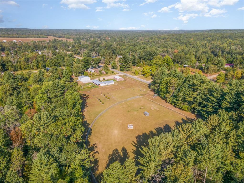 "IF YOU BUILD IT, THEY WILL COME" This one-of-a-kind property-formerly known as Clark Memorial Park in Harrison-offers a full-size regulation baseball field complete with dugouts. Property includes 4 parcels totaling 38+/- acres; the land is a mix of level open areas and wooded trails, with a small pond in the back adding to its charm. Zoned residential improved, this unique property provides endless possibilities. The 3-bedroom, 3-bath home features over 1,400 square feet with a welcoming farmhouse feel. Updates include energy-efficient LED lighting, outdoor solar lighting, on-demand hot water heater, and excellent insulation. Nearly all windows are stationary except the bedrooms, and a generator is included for peace of mind. Outdoor living is just as inviting, with a covered patio and outdoor living space perfect for entertaining and relaxation. The parcel that the buildings are situated on is fully fenced and includes a garden area with apple, plum, peach and pear trees, plus a grape arbor. If you enjoy gardening, then we think you'll love the vegetable garden! Along the trails, youll find wild blackberries and blueberries to enjoy. Walk the trails, or ride; the choice is yours. Two large garages provide ample storage and workspace. One insulated metal building is equipped with heat and an air compressor, while the second, pole-style building is also insulated. This property is a rare find-whether youre looking for recreation, hobby farming, or simply space to spread out, its ready to make your vision a reality.