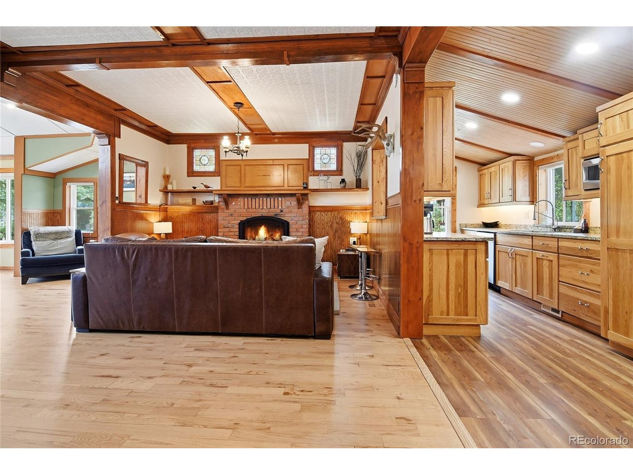 Nestled on 1.57 wooded acres in Buffalo Creek's Christmas Hill community, this exceptional mountain retreat offers a rare blend of historic character, thoughtful updates, and an authentic Colorado mountain lifestyle. Surrounded by towering pines and abundant wildlife, the property offers the privacy, serenity, and natural beauty that define Colorado mountain living.Rich in local history, the home showcases beautiful reclaimed woodwork and stained glass salvaged from the original Pine Library, creating warmth, craftsmanship, and character that simply cannot be duplicated. Thoughtful updates complement its timeless appeal, including a remodeled kitchen, updated bathrooms, hardwood floors, a propane fireplace insert with remote control in the living room, and a professionally installed Jtul cast-iron propane stove on the lower level.Expansive decks invite you to relax, entertain, and enjoy mountain views, while on quiet evenings the sounds of the nearby North Fork of the South Platte River add to the tranquil setting. The fenced backyard, detached two-car garage, and two storage sheds provide plenty of space for vehicles, outdoor gear, hobbies, and mountain living.Served by Buffalo Creek Water, Starlink high-speed internet, propane, and a permitted septic system that was recently pumped, this home offers modern convenience without sacrificing its mountain charm. With no HOA and the Buffalo Creek Trailhead just 0.3 miles away, you'll enjoy access to the Colorado Trail, mountain biking, hiking, fishing, camping, and year-round outdoor recreation.Beyond the home itself, Christmas Hill is known for its welcoming mountain community, where neighbors gather for summer Saturday evening potlucks and many homes have remained in families for generations. Whether you're searching for a full-time residence or a weekend mountain getaway, this is a place where Colorado history, mountain adventure, and community come together to create an exceptional lifestyle.