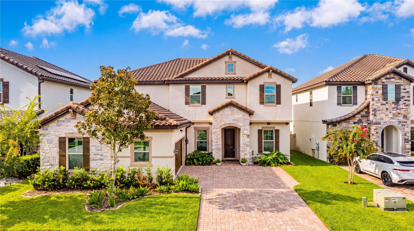 From the moment you step inside, this beautiful Mediterranean-style pool home in Enclave at Windermere Landing makes a lasting impression. Offering 5 bedrooms, 4 full bathrooms, nearly 4,000 square feet of living space, and the thoughtfully designed Camellia floor plan, this home blends elegant design, everyday comfort, and inviting spaces for entertaining. The interior features porcelain tile throughout the first floor, a bright open layout, and generous living spaces that flow naturally from the formal dining room to the family room and kitchen. The gourmet kitchen is enhanced with quartz countertops, a large center island, a walk-in pantry, a butler’s pantry, and plenty of space for cooking, hosting, and gathering. The first floor also includes a guest bedroom, ideal for comfortably accommodating visitors. The study is perfect for a private home office. A large game room adds flexible space for movie nights, play, work, or relaxation. Upstairs, the spacious primary suite offers a true retreat with an oversized walk-in closet and a spa-like bathroom with dual vanities, a soaking tub, and a separate shower. The second floor also offers generously sized bedrooms. The upper-level laundry room adds effortless convenience to your daily routine. The backyard is designed for the Florida lifestyle, featuring a private in-ground pool, covered patio, deck space, and a newly added summer kitchen, creating the perfect setting for entertaining or enjoying quiet evenings at home. Both A/C units were replaced in 2024. Located in Windermere, near Keene’s Pointe, Golden Bear Golf and Country Club, Butler Chain of Lakes, shopping, dining, Disney parks, major roadways, and highly rated schools, this home offers the space, features, and location designed for the way you want to live. Don’t miss this rare opportunity to own a beautifully maintained pool home in one of Windermere’s desirable communities. Schedule your showing today!