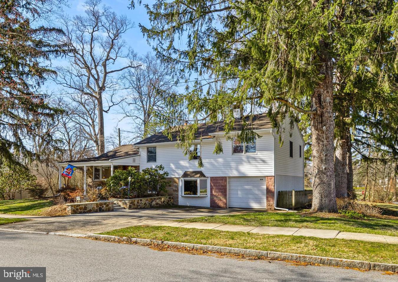 Don’t miss this expanded 4-bedroom, 2.5-bath home in the highly sought-after Garrett Hill neighborhood of Radnor Township—offering walkable access to Clem Macrone Park, Villanova University, train stations, and local dining.A welcoming covered front porch sets the tone for this inviting home. Inside, the entry area (with coat closet) flows into a bright Living Room, thoughtfully defined by a charming vintage church pew panel, with open views to the Dining Room—ideal for everyday living and entertaining.The updated Kitchen is designed for both function and style, featuring generous counter space and abundant cabinetry. Just a few steps down, the oversized Family Room offers a cozy retreat with a wood-burning fireplace and striking stone accent wall. This versatile space also includes a built-in bar and plenty of room for a media area, game table, or fitness zone.The adjacent Laundry/Mudroom has been refreshed with new flooring and newer cabinetry. This level also includes a Powder Room, utility area, and convenient interior access to the oversized Garage.Upstairs, the Primary Suite is uniquely positioned alongside the additional bedrooms—an uncommon feature in many split-level homes. The spacious suite offers multiple closets and a large ensuite bath with a jetted tub and space for a large vanity. Three additional Bedrooms share a Hall Bath with tub/shower combination. A linen closet, additional storage closet, and walk-up access to the floored attic complete this level.Enjoy relaxing and outdoor dining on the rear patio, which overlooks the scenic yard with mature perimeter plantings, including wisteria, hydrangea, and lilac. Partial fencing provides privacy to the rear patio, and there is ample yard for gardening and recreation. The extra wide driveway provides easy parking for multiple vehicles without the need to shuffle cars.Located in the top-rated Radnor School District, this home is just minutes from shops, movies, libraries, restaurants, and other activities in the charming towns of Bryn Mawr and Wayne. With convenient access to the Blue Route and nearby train stations, commuting to Center City, NYC, corporate centers, medical facilities, and the airport is effortless.