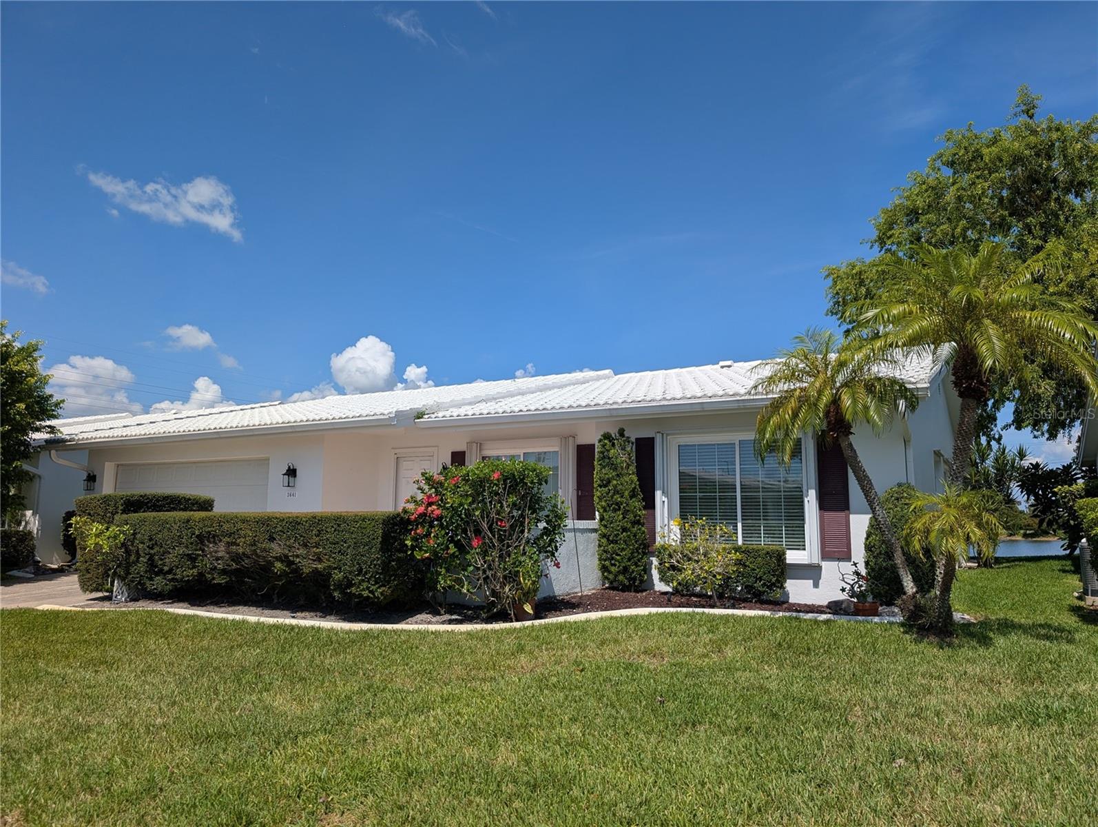 Under contract-accepting backup offers. Location, location, location! This 2BR/2BA/2CG home has a WATER and GOLF course view.  Situated in the Heart of Tampa Bay...the great Florida lifestyle is at your fingertips. Endless activity choices from Bay to Gulf.  This well-maintained 1794 heated square foot "Philodendron" model offers a split floorplan.  Interior features thru out the entire home include 20” tile floors, crown molding, 6” baseboard trim and a neutral décor. The eat-in kitchen is the "Heart of the Home" surrounded by the Living/Dining & Florida room. The stunning updated kitchen features Maytag stainless steel French door refrigerator w/in-door ice/water dispenser, GE stainless steel glass top range/microwave/dishwasher, beautiful quartz countertops, stainless steel double undermount sink, tall kitchen faucet w/pull down sprayer, white cabinets w/brushed nickel hardware, recessed can lighting & inset ceiling with uplighting. Kitchen is surrounded by the living, dining & Florida rooms. The spacious Living room has a large front window.  Guest bedroom & main bath are located off living room.  Guest bath features updated vanity/sink/faucet, mirror, light fixture, comfort commode and offers bathtub w/shower. Dining room is the bridge between the living & Florida room. The Florida room has two large windows that frame the spectacular backyard view, ceiling fan, pass thru window into the kitchen & access to Bonus room.  Screened back porch (added 2019) is accessed from Bonus room. The split floorplan separates bedrooms for privacy.  Primary ensuite bedroom, down hallway off dining room, is next to interior laundry. Primary bedroom has a walk-in closet, ceiling fan w/light & ensuite bath. Primary bath features a gorgeous vanity/double sinks/mirror, medicine chest, comfort height commode and light fixture.  The walk-in shower and commode are in a private “water closet”. Linen closet located in hallway. Laundry room offers a Samsung washer/dryer set, utility sink, extra storage cabinets & access to the garage. The oversized 2 car garage houses the A.O Smith water heater, Overhead reinforced garage door w/Linear door motor, exterior man door, new Eaton electric panel (2026), pull down attic access and a Trane HVAC system (2020). Exterior features include mosaic tile front entry, tile roof (2000), new exterior lighting, gutters/downspout, irrigation system & updated windows. Come join the residents of Mainlands Unit #6, an active 55+ community, offering a variety of social activities, clubhouse, heated in-ground pool & shuffleboard courts. The $415 monthly Maintenance fee includes cable, internet, water/sewer/trash removal, lawn care, reclaimed water irrigation, exterior painting and all common ground maintenance! The community is built around an 18-hole public golf course and is located adjacent to Freedom Lake Park which offers paved walking paths around 2 lakes, an outdoor workout area, playground, picnic pavilions, & two dog parks! A well run and maintained community with easy access to nearby parks, fitness centers, shopping, restaurants, churches, medical care, sports/music/arts venues, interstates, two airports & the Gulf beaches! 2 pets are welcome! Don't miss this one-of-a-kind opportunity to "live" the Florida Lifestyle!