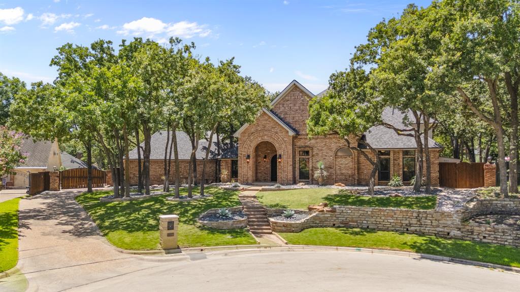 The ultimate entertainers paradise is now ready for you! Located in the sought after Woodland Hills Colleyville subdivision.  Loaded with upgrades and updates. 4 bedrooms, 3 on the first floor, study, game room or formal dining all flowing to over 700 sqft of  gorgeous outdoor living space.  Entertain your friends with your own wood fired pizza oven, have a pool party or sink puts on the private putting green.  If working out in the upstairs exercise room or just chilling in the movie room is more your style it's all here for you.  This home also offers a wonderful 300 plus sqft workshop or man cave with electricity, attached to the 3 car garage.  Hand scrapped hardwoods flow through out the majority of the home. Recent paint both inside and out make this home feel close to a new.  The roof and gutters were replaced in 2023 along with low maintenance landscape, sod, pool updates & putting green. A Generac generator gives extra protection against loss of power.  Too many features to list, so make plans to visit today! Located minutes to major highways, DFW airport, wonderful shopping and entertainment.  Grapevine Colleyville ISD. Subdivision offers private ponds, walking trails and park. Seller is a Licensed Realtor, Listing Agent is related to Seller. WOW!