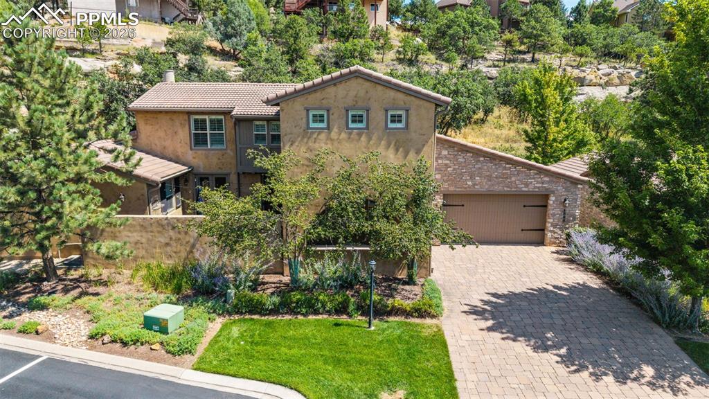 REMODELED KITCHEN * PRIVATE FRONT COURTYARD * SIDE PATIO * FRESH INTERIOR PAINT & NEW CARPET * WETBAR * MAIN LEVEL STUDY/BEDROOM * OPEN CONCEPT FLOOR PLAN * UPPER-LEVEL PRIMARY SUITE * CUSTOMMASTER CLOSET* BEAUTIFUL WOOD FLOORS * BACKS TO SCENIC BLUFFS Nestled among the peaceful bluffs of Peregrine, this exquisite villa offers a lifestyle of relaxed elegance and effortless living. From the moment you arrive, the private front courtyard with a custom Tuscan mural invites you to unwind and embrace Colorado's coveted outdoor lifestyle. Inside, the open and airy floor plan is perfect for both everyday living and entertaining. The remodeled kitchen is a chef’s dream—featuring expansive quartz countertops ideal for meal prep or showcasing a buffet, complemented by a charming breakfast nook beneath a stylish light fixture. The great room is warm and welcoming, centered around a cozy gas fireplace and seamlessly connected to the dining area. Natural light fills the space, creating a vibrant and inviting ambiance perfect for hosting friends and family. Fresh neutral paint throughout the main and upper levels, paired with new plush carpet, adds a modern and elegant touch. A unique window and window seat halfway up the staircase perfectly frame the surrounding mountain beauty—an architectural gem that captures the spirit of Colorado living. Upstairs, the spacious primary suite is a true retreat, complete with a luxurious 5-piece bath and a generous walk-in closet featuring custom California Closets. An additional en-suite bedroom on this level offers privacy and comfort for guests or loved ones. The finished basement expands your living options with two additional bedrooms—one highlighted by a rustic barn door—a stylish wet bar, and ample space for recreation or relaxation. Additional features include a main-level study/bedroom, central A/C, low-maintenance stucco exterior, and a durable tile roof. Located just minutes from trails, parks, tennis/pickleball courts.