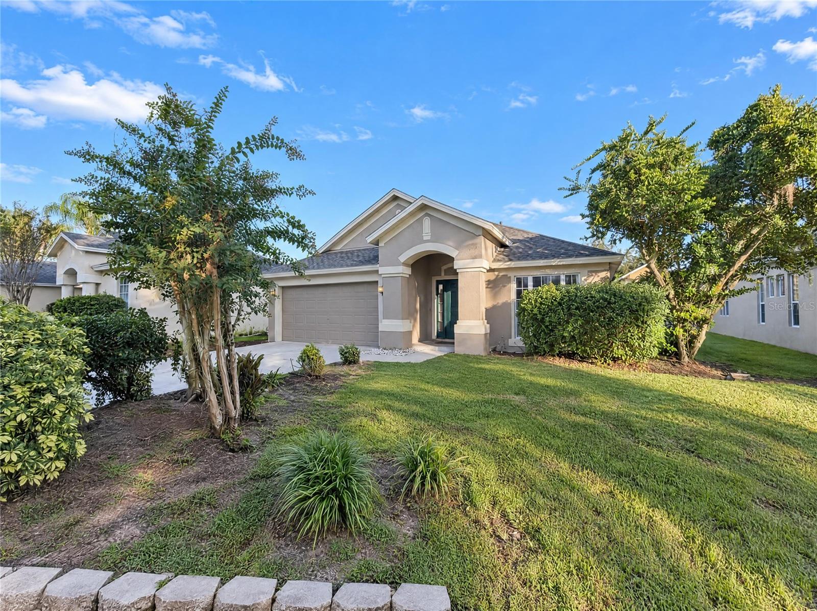 30447 Iverson Dr is a one-story Wesley Chapel home built in 2000 with bright, open living spaces. The kitchen features ample counter space and white cabinetry, creating a well-equipped space for cooking and entertaining. The main living area includes sliding glass doors. The primary bedroom features a walk-in closet for convenient storage and organization, while the primary bathroom has double sinks for everyday convenience and a separate tub and shower. Additional bedrooms include ceiling fans, and a hall bathroom has a tub and shower combination. A covered patio and screened saltwater pool create an expansive area for relaxation and entertaining. A two-car garage completes this well-maintained residence with practical amenities and comfortable living spaces throughout every room. Included 100-Day Home Warranty with buyer activation