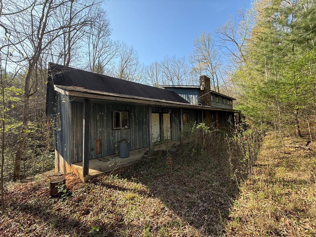 Home on 9 acres out in the country. Paved road access and a large creek along one side of the property. Some pasture along the creek. House is a three bedroom two bath that needs some loving. Private well and private driveway. NO HOA.  Bring your tools and build your dreams. listen to the Noisey stream from the large covered porch.