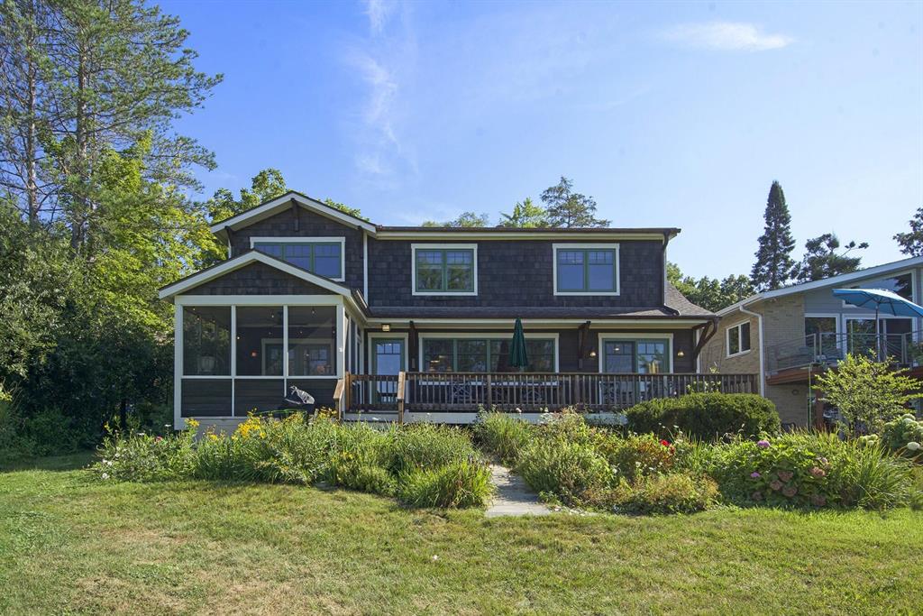 Turnkey cedar-shingled charmer on 150-acre private, no-motor lake with no public access--offering peace, privacy, and natural beauty. Built in 1948 and renovated in 2018, this 4-bed, 3-bath home blends vintage charm with modern comfort. Every bedroom overlooks the lake; baths feature tasteful, high-quality finishes. The bright, updated kitchen features Viking and Bosch appliances, and the enormous laundry/mud room offers the perfect place to dry off the children and dogs.  Two upstairs family rooms provide flexible space and the attached 2-car garage includes a finished loft--ideal for an office, guest suite, or children's playroom. Enjoy your morning coffee in a spacious lakeside screened porch that opens into a dining room with panoramic views, seating sixteen.  The home features a large lakeside cedar deck, a boathouse that stores up to five paddle boards and kayaks, and a raised bluestone patio where you can watch evening sunsets. Perfect as either a year-round residence or getaway!