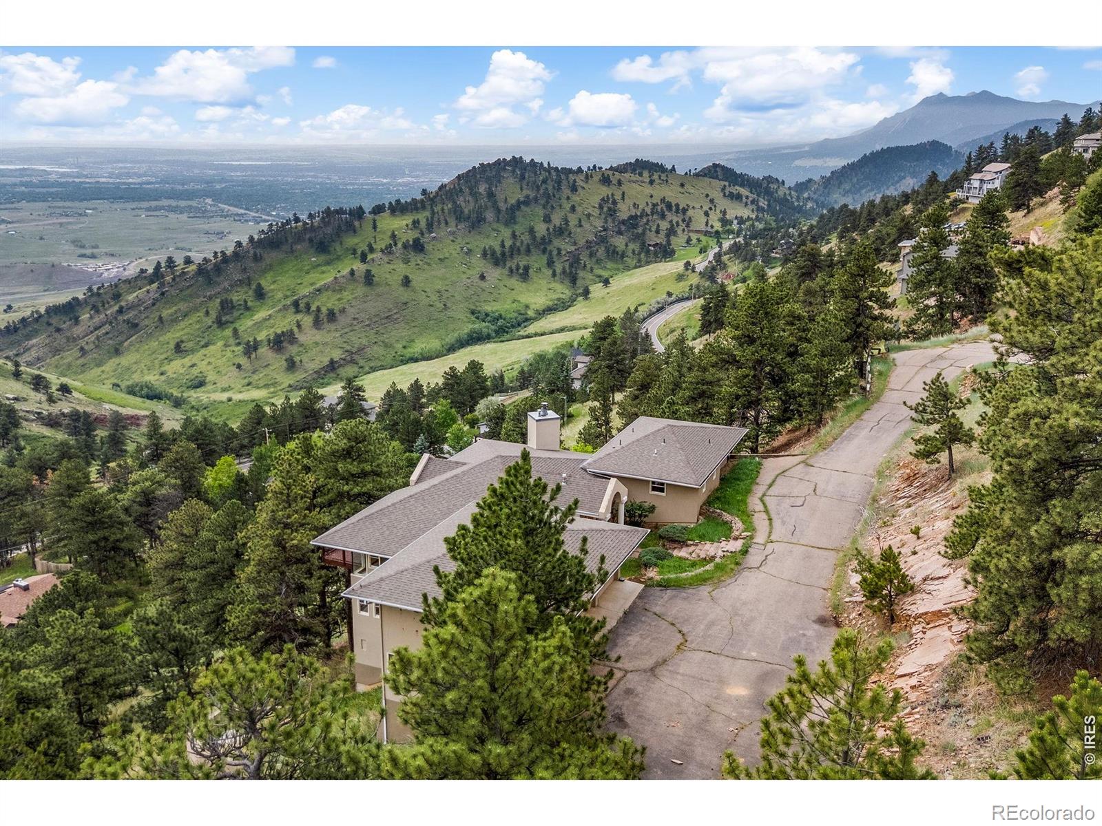 Perched on a private 1.74-acre lot with some of the most breathtaking mountain and valley views in the region, 6196 Red Hill Road offers a rare blend of seclusion and potential. This is more than just a home; it's a sprawling 5724-square-foot canvas awaiting your vision. Located just a scenic five-mile drive from the heart of downtown Boulder, this property provides the perfect escape without sacrificing proximity to the city's vibrant energy and amenities. Built in 1990, the residence features an expansive open-concept layout designed to pull the outdoors in. Soaring ceilings and massive windows flood the living spaces with natural light, framing the rugged beauty of the Front Range from nearly every angle. With four spacious bedrooms and four bathrooms, the floor plan offers a generous foundation for a modern transformation. Whether you imagine a sleek contemporary retreat or a warm mountain sanctuary, the bones of this home are ready for a creative revival. Outdoor enthusiasts will find themselves perfectly situated, with world-class hiking and biking trails accessible just moments from the front door. The property also includes an oversized 3 car attached garage, providing ample space for vehicles and gear. Families will also appreciate the access to top-rated Boulder Valley schools, including Foothill Elementary, Centennial Middle, and Boulder High. If you've been searching for a private oasis that feels worlds away yet remains connected to everything that makes Boulder iconic, this is your opportunity to build the dream.
