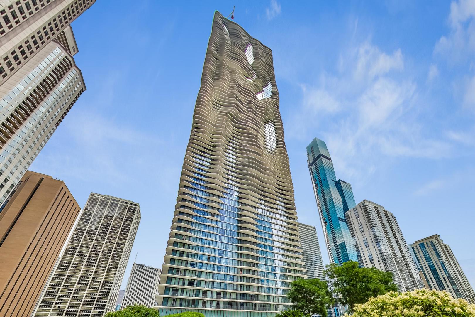 The most spectacular views in the only three bedroom + three full bath sky home @ Chicago's architecturally acclaimed Aqua (the highly sought after "05 tier").  In 2022, a fresh makeover of "Mocha" hardwood floors, luxury stainless Bosch appliances & plush carpet in bedrooms took place.  Bring your designer to update the rest of this spacious 2,022 sq. ft. condominium.  Added features include custom built-in cabinets in primary suite, motorized shades in each bedroom and living room. Every closet is professionally organized. Panoramic views from this amazing 262 sq. ft. wrap around terrace gives you dynamic 360-degree views of Lake Michigan, Navy Pier, Chicago River and the city's iconic skyscrapers. Contemporary and classic decor blend perfectly the moment you step foot onto the exotic hard wood floors in the foyer, living room and dining room. Chef's kitchen features luxury imported cabinetry, top of the line stainless appliances, and breakfast bar. Primary bedroom suite features custom built-ins, spa bath with radiant floors, whirlpool, spacious separate shower, double vanity plus dressing room closets with professional organization and NEW plush carpeting. 2nd bedroom ensuite with lake views boasts a comparable luxury bathroom of exquisite tastes and NEW plush carpeting. 3rd bedroom with skyline views gives one flexibility as an office for work from home professionals. 3rd full luxury bathroom. Aqua's amenities are second to none. Resort style features indoor heated swimming pool, outdoor swimming pool, grilling area, cabanas, dining al fresco, hot tub, fitness center, basketball court, jogging path, billiards room, theatre room, business center, two business lounges, easy access to Starbucks, restaurant at Radisson Blu and so much more! Walk to Navy Pier, the Riverwalk, Maggie Daley Park, the "Magnificent Mile" & Museum Campus. Run or bike along the lakefront. Prime Heated Garage Parking + Storage INCLUDED! Live the "good life" at Aqua where Lake Shore East meets Millennium Park.