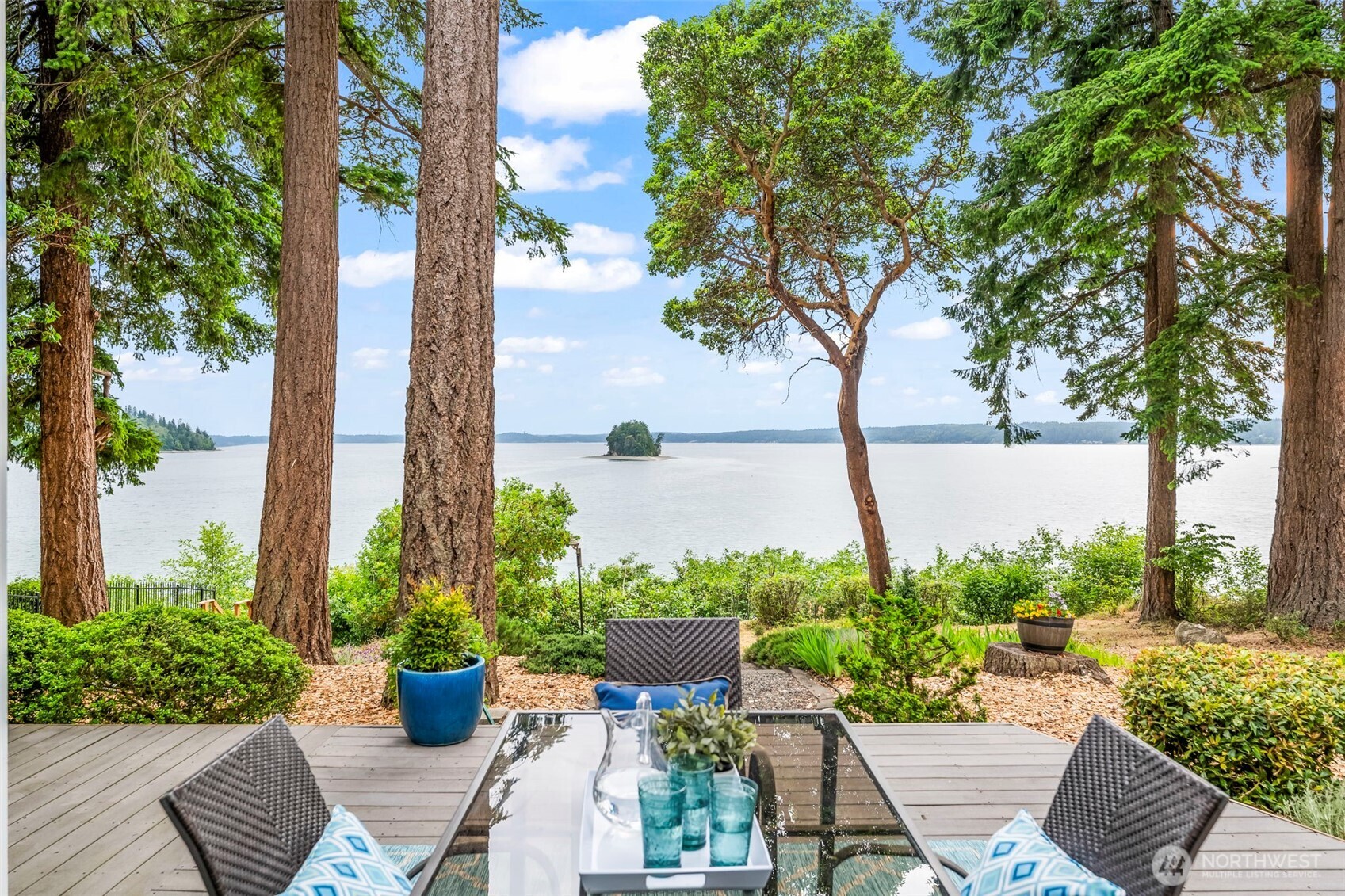 Cradled in old growth evergreens and kissed by the sea breeze on beloved Raft Island, this timeless waterfront Craftsman feels like a peaceful escape—yet it’s home. Incredible southern views of Henderson Bay and Cutts Island fill each space with beauty, light, and calm. The soaring great room, French doors that bring the outdoors in, and natural wood tones define the home's warm, comfortably elegant style. Thoughtful main-level living, includes a view-filled primary suite, office and the expansive deck.  You'll love the charming original cabin, now an ADU. Stairs lead to your 85 ft beachfront, perfect for quiet walks or salty adventures. Just 6 miles from the heart of Gig Harbor, Raft Island life feels worlds away like a vacation each day