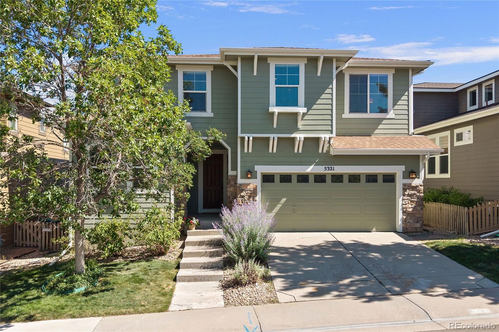 Sprawling mountain and downtown views meet close proximity to the Southridge recreation center — nothing else in Highlands Ranch compares. Tucked into The Hearth, where walking trails lead to the closest schools, parks and the Southridge recreation center, this light-filled two-story home is ready for its next chapter. Peace of mind arrives in the details: newer HVAC, roof, and water heater are all in place, plus fully paid-off solar panels. Enjoy stunning sunset and city views from the upper deck, where distant rear neighbors preserve a sense of privacy above a low-maintenance yard that meets your busy lifestyle with a 7-minute-mow. Beyond the charming red front door, 18ft ceilings and a wall of windows fill the space with light while framing mountain views. A see-through fireplace separates the great room from a cozier second living area with built-in surround sound and sliding glass door access to the deck. Corner windows carry the mountain views into the large kitchen where ample prep and cabinet space (including pantry storage) surround an island, and stainless-steel appliances create function. Dining options — from the breakfast bar to the casual eat-in — complement the formal dining room off the great room. Upstairs, a hallway open to below sets the stage for a loft that soaks in light and views through clerestory windows. The primary suite sits just around the corner, its entryway splitting toward a bedroom with the best views in the home, and a bathroom finished with a luxurious soaking tub and a brand-new, glass-enclosed walk-in shower. Off the flexible loft, currently used as a gym, two secondary bedrooms share a full bath with dual sinks and a private water closet, and a laundry room completes the picture. An unfinished garden-level basement, already roughed in, waits as a blank canvas for whatever comes next, alongside a two-car garage. Outdoor living, indoor possibilities, and views you won't find anywhere else: this is Highlands Ranch at its best.