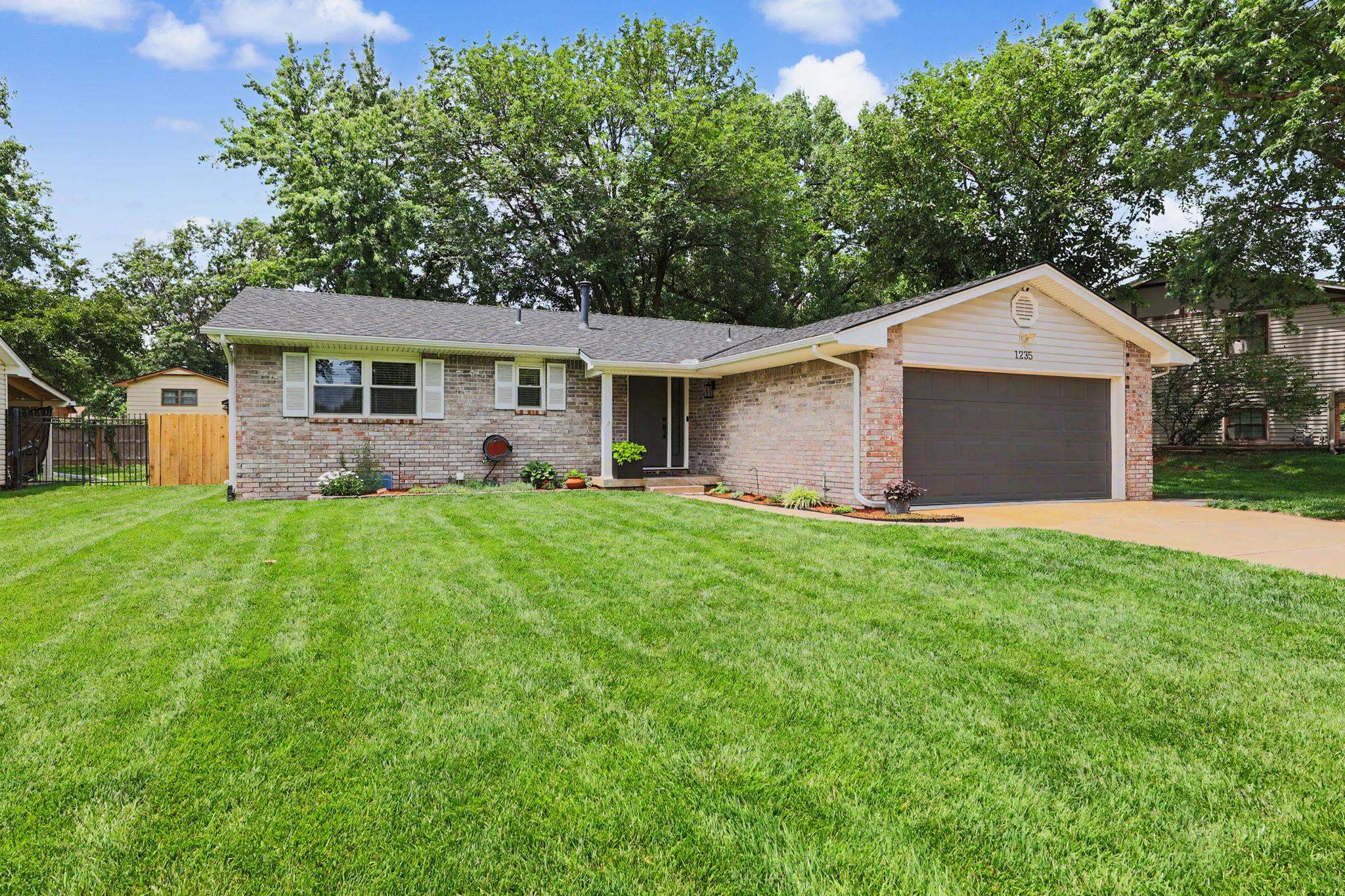 Welcome to 1235 Sunset located in one of west Wichita's most desirable zip codes. This impeccably maintained home shows pride of ownership and is abundant from the moment you arrive.  The stunning, recently updated kitchen is the heart of the home, featuring gorgeous new marble countertops, abundant workspace, and timeless style that will impress even the most discerning buyer. Beautiful, engineered hardwood flooring flows throughout the main level, creating a warm and elegant atmosphere.  The spacious primary suite offers a luxurious retreat, complete with a beautifully remodeled master bathroom featuring tasteful, modern finishes. Every update has been thoughtfully completed with comfort and style in mind.  The finished basement provides additional living space and includes a versatile fourth non-conforming bedroom that is perfect for a home office, workout room, hobby space, or guest area. Whether you need extra room for work or play, this flexible space delivers. The large family room is perfect for movie nights with custom built shelving and storage. Major mechanical updates provide peace of mind, including a HVAC system that is only 2 years old, a hot water tank that is 2 years old, and a roof that is approximately 1.5 years old.  Step outside to an amazing backyard oasis featuring a sprinkler system supplied by a private well, making lawn maintenance both easy and economical. The finished garage is a standout feature, offering air conditioning, plenty of storage space, and comfort year-round.  This home has been meticulously cared for and thoughtfully updated, leaving nothing for the next owner to do except move in and enjoy. Opportunities like this don't come along often. This move-in-ready property offers exceptional updates, quality finishes, and a level of care that is hard to find.  Schedule your private showing today—homes of this caliber do not last long!  Call listing agent today!