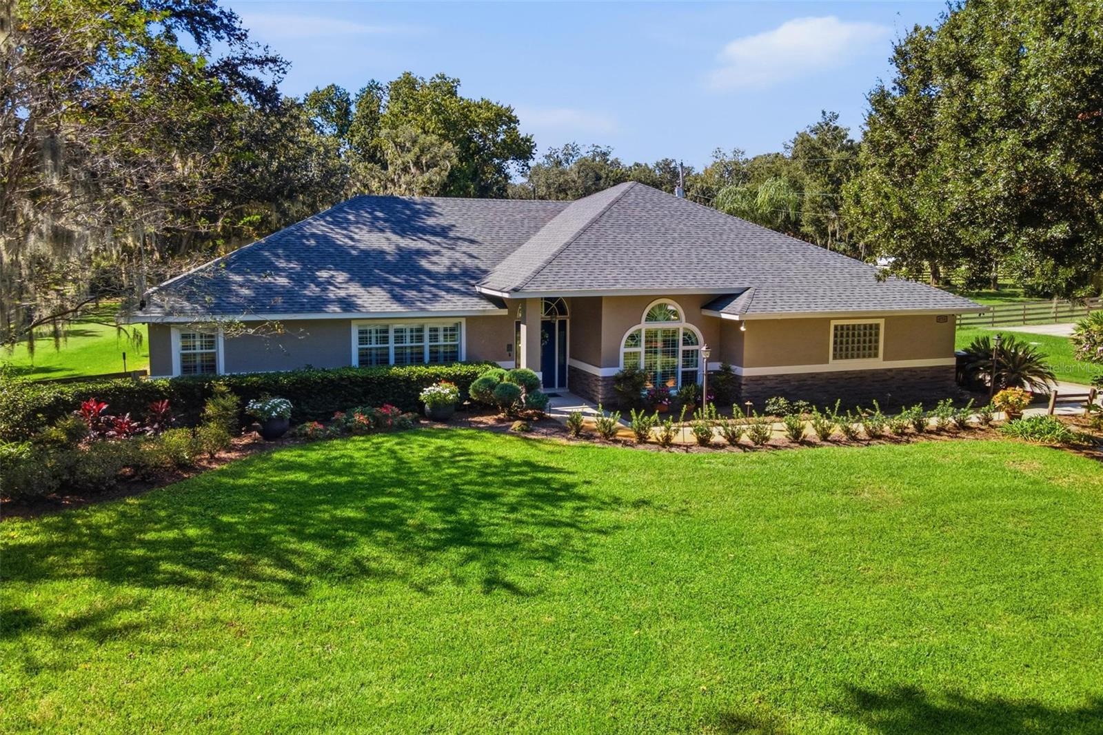 Welcome home to this spacious and beautifully updated property offering an impressive combination of indoor comfort and outdoor living! Major improvements include a newer roof September 2024, a 2022 water heater, and A/C replaced in 2015. Inside, you’ll find vaulted ceilings, crown molding, plantation shutters, chair molding in the dining room, and a thoughtful mix of wood, tile, and carpet flooring throughout. The remodeled kitchen (2022) features attractive two-tone cabinetry, a beautiful backsplash, built-in pantry, new refrigerator, and a charming built-in seating area in the breakfast room. The spacious living area offers surround sound and two sets of French doors, creating an easy connection to the outdoor living spaces. The primary suite features a large walk-in closet and a beautifully remodeled primary bath (2022) complete with a walk-in shower with built-in ledge, heated floors, soaking tub with chandelier, and dedicated makeup vanity area. The hall bath was remodeled in 2021 and features a handicap-accessible walk-in shower and dual vanities. Generously sized closets provide plenty of storage throughout the home, including two large closets in the second bedroom. The third bedroom features a loft area, adding extra versatility. A spacious laundry room includes a utility sink, built-in ironing board, and linen closet, while the bath located off the laundry room features a newer vanity. Outside is where this property really stands out! Enjoy the expansive 18x38 screened porch and an outdoor kitchen equipped with a grill, exhaust hood, countertops, and cabinetry, perfect for entertaining. The property also features a substantial 47x23 pole barn and a separate 8x5 generator room, providing excellent additional space for storage, equipment, hobbies, or recreational toys. With extensive updates, abundant storage, multiple entertaining areas, and exceptional outdoor amenities, this home offers features you simply don't find every day.