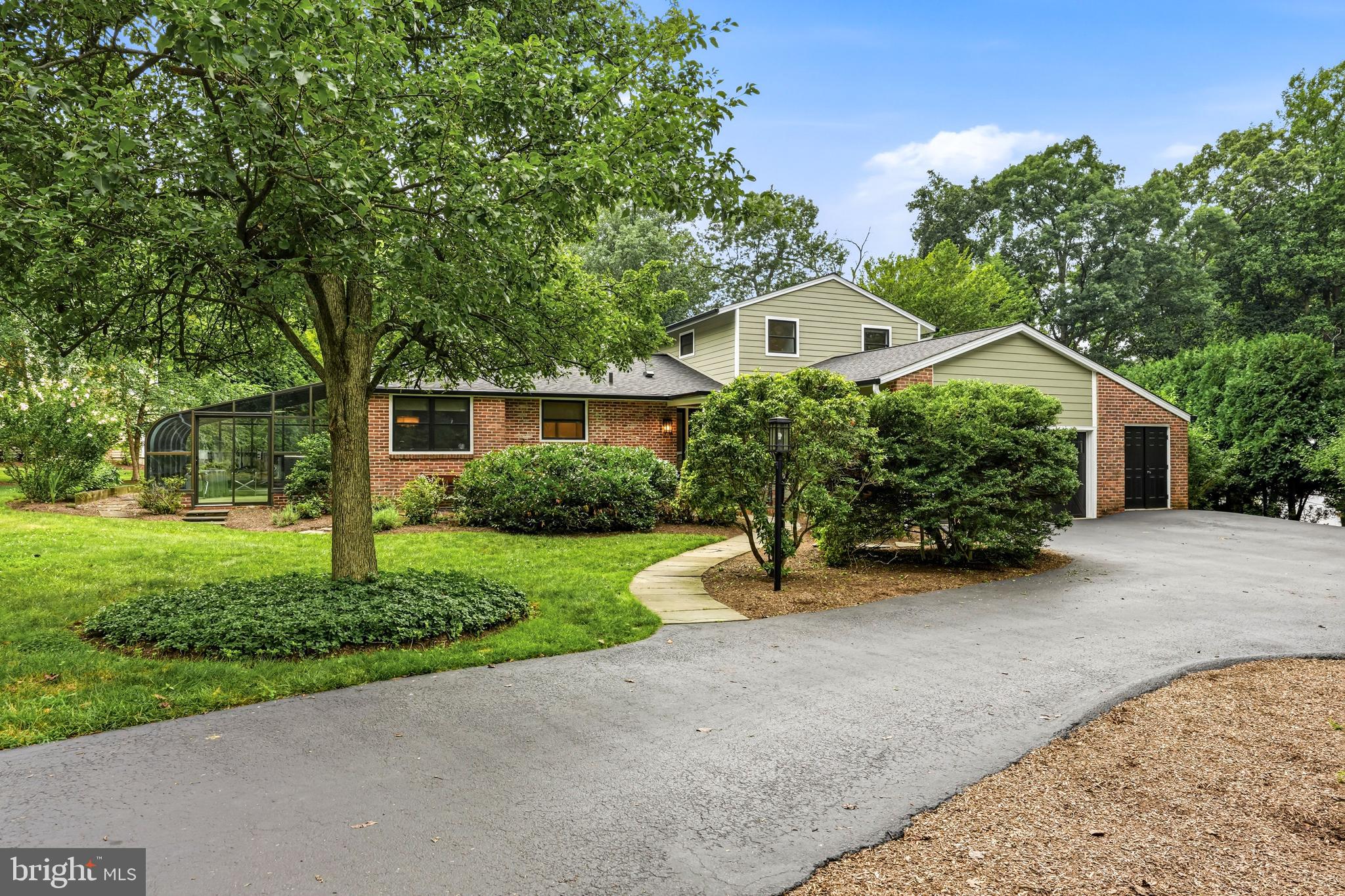Christmas in July has arrived—and the gift everyone will be talking about is 749 Bair Road. Nestled in Berwyn's coveted Woodlea neighborhood, this exceptional home sits on a perfectly level .76-acre lot, offering the rare combination of timeless Main Line charm, generous living spaces, and an unbeatable walkable lifestyle. Stroll to top-rated schools, the train, restaurants, and neighborhood favorites—all while enjoying the peaceful setting of one of Berwyn's most beloved streets.  A spacious horseshoe driveway and flagstone walkway welcome you to the stately front entrance, where a grand foyer and sweeping staircase set the tone for what lies beyond. Rich hardwood floors lead you into an expansive great room, where built-in bookshelves, a classic brick fireplace, recessed lighting, and panoramic views of the lush backyard create an inviting space for everyday living and memorable gatherings.  The well-appointed kitchen is designed for both function and entertaining, featuring beautiful wood cabinetry, Corian countertops, a gas cooktop, Sub-Zero refrigerator, center island, pantry, and abundant workspace. Just beyond, the dining room showcases authentic Main Line character with exposed wood beams, custom built-ins, a bar area, and rich wood-paneled walls that make every dinner feel like a special occasion. The adjoining sunroom, with its warm terra-cotta tile floors and walls of windows, offers the perfect place to enjoy your morning coffee or unwind at the end of the day, no matter the season.Convenience meets comfort with a desirable first-floor primary suite, complete with direct access to the flagstone patio, a spacious walk-in closet, and a luxurious bath featuring a soaking tub, separate shower, double vanity, and private water closet.  A second bedroom with its own full bath and a powder room complete the main level.  Upstairs, two generously sized bedrooms are connected by a thoughtfully designed Jack-and-Jill bathroom with a double vanity and ample linen storage, providing comfortable accommodations for family and guests alike.  The finished lower level expands the home's versatility with a spacious family room featuring French doors to the side yard, a wet bar for effortless entertaining, a full bath, laundry room, and abundant storage and workshop space.  Additional highlights include efficient gas hot water heat, central air conditioning, a whole-house backup generator, an attached two-car garage, and additional storage.  And then there's Woodlea—where neighbors become lifelong friends. Annual luminary nights, neighborhood cocktail parties, the familiar sound of the ice cream truck, and abundant wildlife create the kind of community people hope to find but rarely do.   749 Bair Road isn't simply a beautiful home—it's an invitation to experience the Main Line lifestyle so many dream about. Come see why this is the one you've been waiting for.