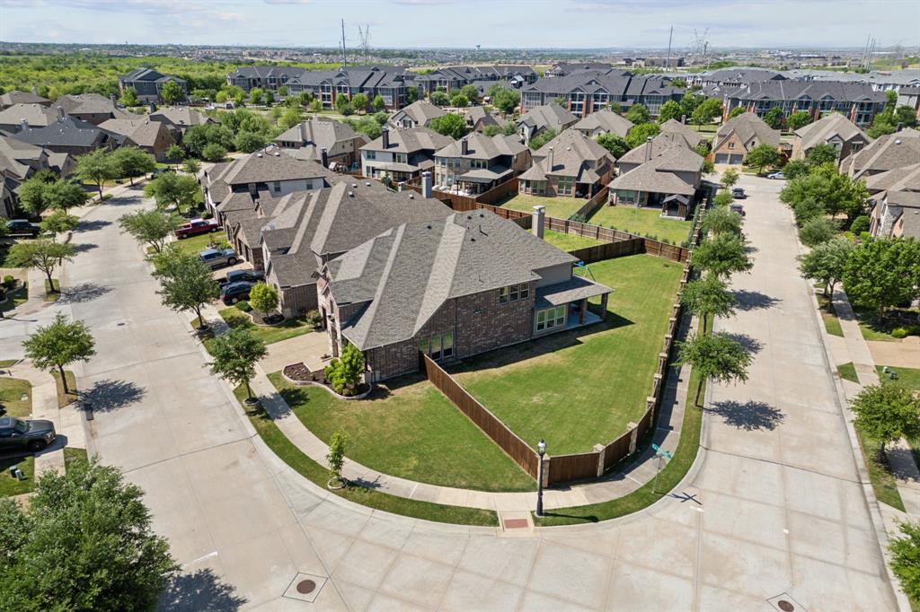 This homesite is TWICE the size of the standard lot in this section of CH.

IF YOU USE SELLERS  preferred lender get up to $9,000  in closing costs or to buy down your rate *** with executed contract by July 30th.

This stunning residence gracefully positioned on a premier oversized corner lot in the prestigious Castle Hills community of Lewisville, Texas. This elegant two-story home offers 5 spacious bedrooms, 4 full bathrooms, and an expansive 3,846 sq ft of thoughtfully designed living space blending everyday comfort with timeless sophistication.
Step inside to a light-filled layout that features 2 bedrooms and a private study on the main level, ideal for multigenerational living or remote work. Gleaming hardwood floors, high-end finishes, and soaring ceilings enhance the open-concept design. At the heart of the home, the chef’s kitchen showcases polished granite countertops, upgraded stainless steel appliances, and abundant cabinetry — all flowing seamlessly into the living room anchored by a cozy gas log fireplace. Upstairs, a spacious game room and dedicated media room create the perfect place to play, unwind, and entertain — ideal for movie nights, game days, or family fun. Outside, the home is situated on an exceptional homesite with a generous backyard offering ample space to bring your dream outdoor oasis to life — envision a sparkling pool, sports court, or custom playground visible from both the kitchen and covered porch. Residents of Castle Hills enjoy resort-style amenities including a luxury clubhouse, sparkling pool, multiple parks, a state-of-the-art fitness center, and tennis and basketball courts. Perfectly located minutes from world-class shopping, dining, and entertainment at Grandscape, Legacy West,  The Shops at Legacy, with easy access to Highway 121 and DNT. Zoned to highly-rated Memorial Elementary STEM School, this home offers the perfect blend of luxury, convenience, and community.