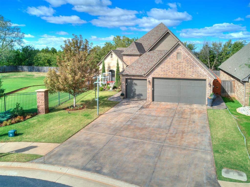Thoughtfully upgraded single-level home in gated Meritage Park, offering low-maintenance living on a greenbelt lot. The open living area is anchored by a gas-log fireplace and flows into a well-appointed kitchen featuring a built-in gas range, double ovens, a new beverage refrigerator, added cabinet and under-cabinet lighting, and convenient pantry outlets, ideal for the coffee pot or toaster to be out of sight. The office has a walk-in closet and can be used as the 4th bedroom.The covered patio and outdoor kitchen extend the living space into a private backyard retreat enhanced by a waterfall feature, new stained cedar fencing, updated landscaping, decorative rock, edging, rain-chain gutters and a newly added ceiling fan. The coordinating outbuilding has been painted to match the home and improved with heating, air conditioning, electrical service and lighting—creating a versatile space for a workshop, studio, hobbies or additional storage.Additional improvements include fresh interior paint throughout, spray-foam insulation in the attic, a water softener and filtration system, exterior security cameras, under-eave outlets for holiday lighting, new garage shop lights, expanded attic and garage electrical outlets, attic lighting, and a Rain Bird WiFi sprinkler controller.Meritage Park offers gated entry, a neighborhood pool, maintained common areas and lawn-maintenance benefits including fertilizer & weed treatment in a convenient Edmond location near Covell Road and Santa Fe Avenue. This move-in-ready property combines comfortable everyday living with meaningful upgrades inside and out. This is one of the best lots in the neighborhood with a large green belt area on the west side and there isn't a house behind, there are wooded trees, so it's like it's own little private oasis.