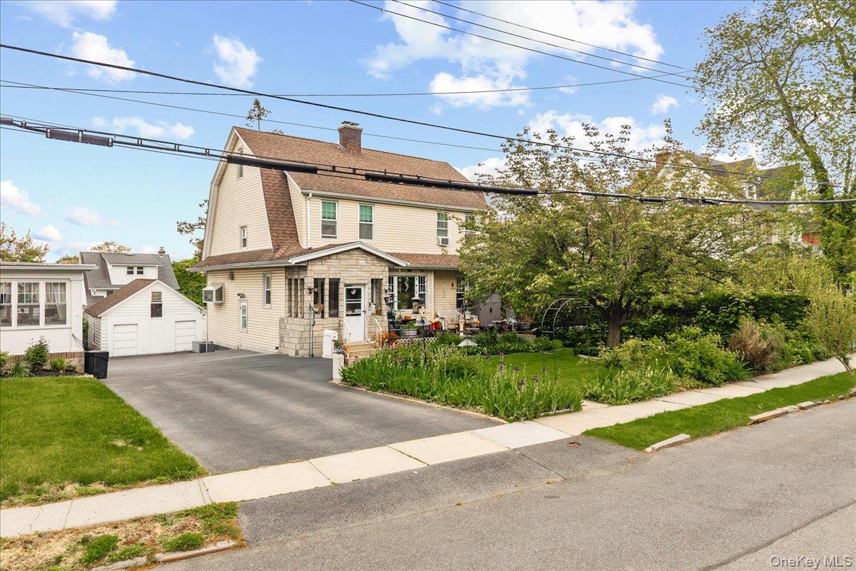 Incredible opportunity to restore and reimagine this spacious Colonial located on a quiet, tree-lined street in a highly desirable neighborhood. Offering 5 generously sized bedrooms and 2 full bathrooms across three levels, this home is filled with character, potential, and timeless Colonial charm. The second floor features four bedrooms and a full bath, while the third level includes a fifth bedroom, additional full bathroom, and attic access. The main level offers a classic layout with a formal dining room, fireplace, and hardwood floors ready to be brought back to life. Being sold strictly as-is, the home will require updates and improvements throughout, but the size, layout, and location make it a rare value with tremendous upside potential. Additional features include an unfinished basement offering expansion possibilities, excellent storage space depending on your needs. The level backyard offers space for outdoor enjoyment and gatherings, while the detached two-car garage adds convenience and additional storage.  Bonus, a whole-house generator already in place. This Colonial presents a rare opportunity to own a substantial home in a sought-after location. Conveniently located near schools, shopping, houses of worship, and public transportation, this property is perfect for buyers looking to customize a home and build equity.