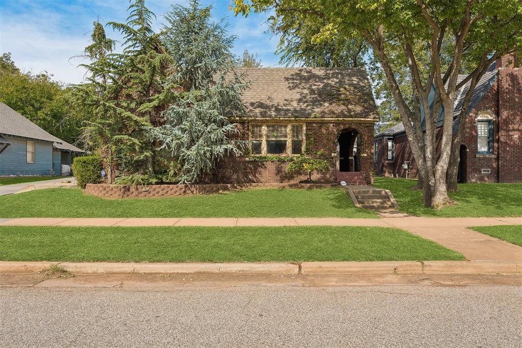 Welcome to Paseo!! If you've been looking for room to sprawl out and entertain in the premier arts district of OKC, look no further! This charming Tudor style home was once a duplex but is now one single-family home offering two bedrooms, two bathrooms, and an absolute abundance of living space. Whether you're looking for more room for dinner parties or an in-home office, with over 1600 sq ft of living space, this darling 2 bed house is far from cramped! No, you aren't seeing double! Two living rooms both with Frankoma tile accented mock fireplaces, an oversized kitchen with tons of storage and two dinette spaces - great for an in-home office, lounge, or reading nook! With an indoor laundry, a fully fenced backyard, and a detached 2 car garage with private, enclosed access, you have all the modern amenities in a historic neighborhood! Enjoy both the day and night life of Paseo Arts District - from First Friday open galleries to brunch at Picasso's, you'll be in the heart of it all! Valuable updates include new roof on both the house and garage in 2018, A/C replaced 2021, A/C condenser replaced 2025, and comprehensive foundation work completed 2026. Don't let the naked floors scare you! Seller will re-install carpet in bedrooms over new sub-floor with acceptable offer. Don't let this charming Tudor cottage pass you by! Schedule your private showing and envision joining the welcoming community of Paseo in a home you can actually host in!