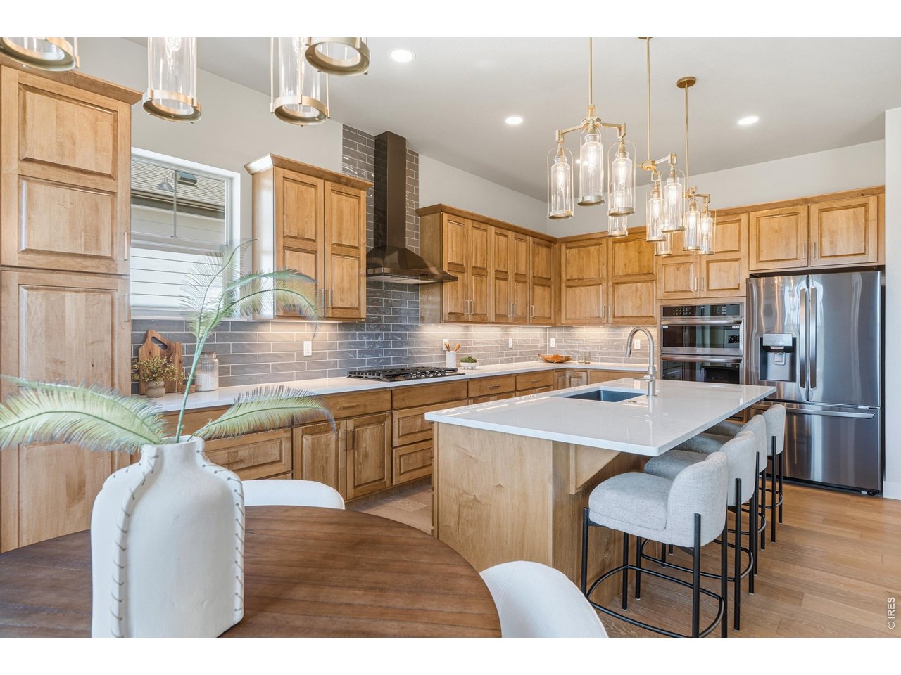 Fricke Custom Homes built this one right! A 6-bedroom, 5-bath 2026 new build with a main-level bedroom with ensuite bath, an upstairs primary retreat, and a finished basement with two more bedrooms and a full wet bar. Room for guests, extended family, or true multi-generational living. Over $40,000 in builder upgrades come standard here, not as costly add-ons.The chef's kitchen anchors the open main level: large quartz island, soft-close cabinetry, black stainless appliances, and a gas range with hood - opening to a living room with a floor-to-ceiling stone fireplace and engineered wood floors throughout. A separate main-level flex room adapts to whatever you need - home office, formal dining room, playroom, or den. Step out to a covered Trex deck with iron railing backing to open space. Upstairs, the primary suite features a luxury spa bath with soaking tub, walk-in shower with a view, and a walk-in closet connecting directly to the laundry room. Two additional bedrooms and a full bath complete the level. The main-level bedroom with ensuite works as a guest suite or home office, plus a convenient powder room for the main living area. Built to last: dual-zone HVAC, tankless water heater, 3-car insulated tandem garage, a basement wet bar with FULL-SIZE refrigerator and dishwasher (not the undersized bar versions), quartz counters, composite sinks, and full front-and-back landscaping with sprinklers. Metro district amenities include a pool, hot tub, fitness center, and clubhouse. Easy I-25 access to Fort Collins and Loveland. Preferred lender offering a rate incentive!