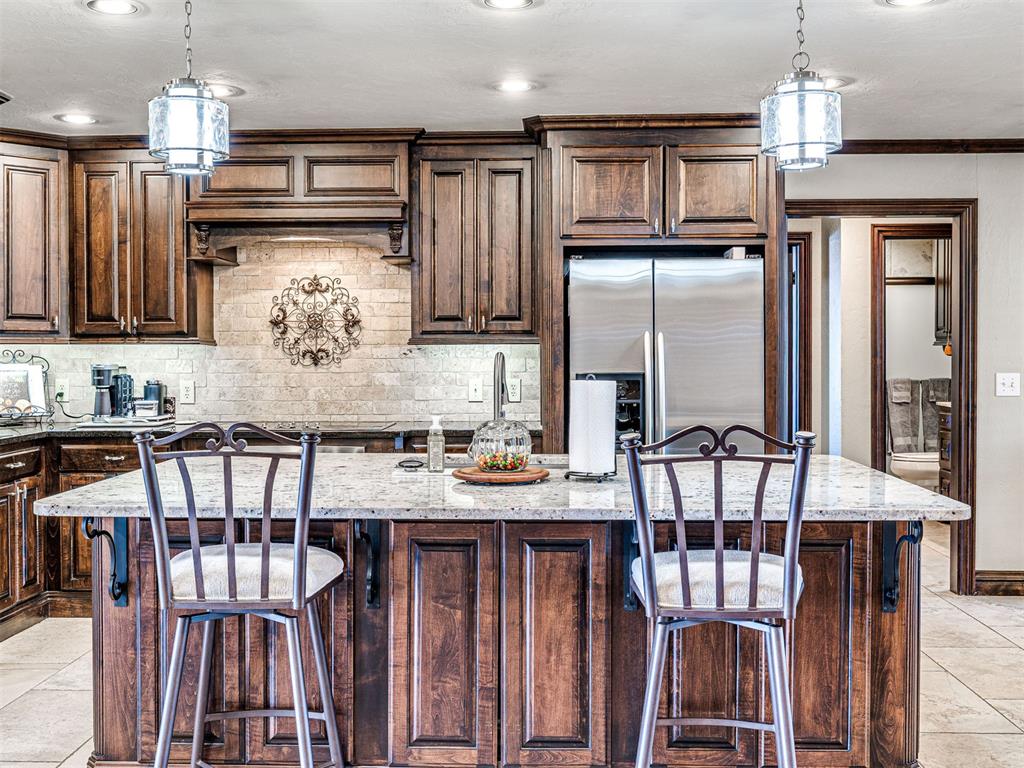 This Gorgeous Executive Home is on ONE Level with 3632' total square feet, 4 Beds, 3 Baths, 2 Living Areas, & a 3 Car Garage. Updates have been done including a Large Island with an open concept floorplan opening up the Large Kitchen, Island, Living Room, Breakfast Nook, & Formal Dining. There are 2 Living Room areas and 2 Fireplaces with Gas Logs in each of the 2 Living Rooms. ROOF replaced in 2024 & Full Guttering with Gutter Guards,  Huge Kitchen with Stainless Steel Appliances, Pull-Out Shelving, Massive Island, Storage Galore, Double Ovens, Pantry, New Dishwasher (2023). This Home has been Maintained Meticulously & is Pristine: Brand new Carpet installed in Master/Primary Bedroom & Main Living Room Jan 12, 2026. Master Bedroom & Living Rooms had Glass Doors replaced in 2021. Both Hot Water Tanks replaced: one  in Nov 2025 & one in Nov 2021, and both HVAC units replaced in August 2021 with Trane Units, Fence replaced in 2021 with Metal Poles. Garage painted & LED lights added. Soffit lights 2021 (front & east side added)