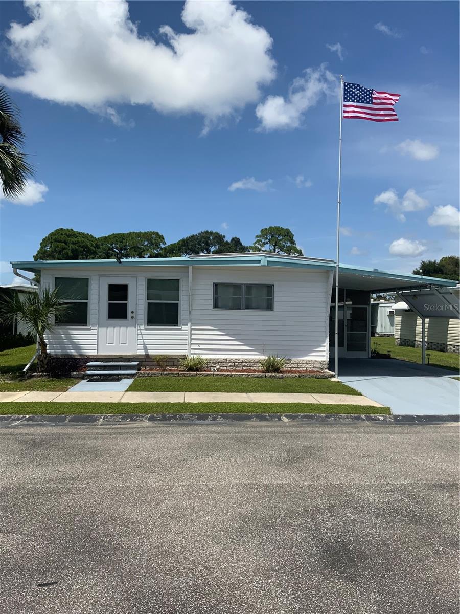 Welcome to this spacius maintained 2-bedroom, 2-bath home featuring a desirable split floor plan and a generous  open layout. The enclosed Florida room expands the living space to approximately 1,046 square feet, offering plenty of room to relax or entertain.Recent updates include new flooring and subflooring completed in 2025, a roof approximately 5 years old, and HVAC installed in 2019. Enjoy the outdoors from the large screened porch, and take advantage of the additional storage room with laundry and convenient covered carport.Located in a well-maintained 55+ community, residents enjoy a community pool, shuffleboard courts, and community center, all surrounded by beautifully kept grounds. The low monthly fee of just $230 includes the land share, making this an attractive and affordable Florida lifestyle opportunity.This home has been lovingly cared for and is ready for its next owner!
