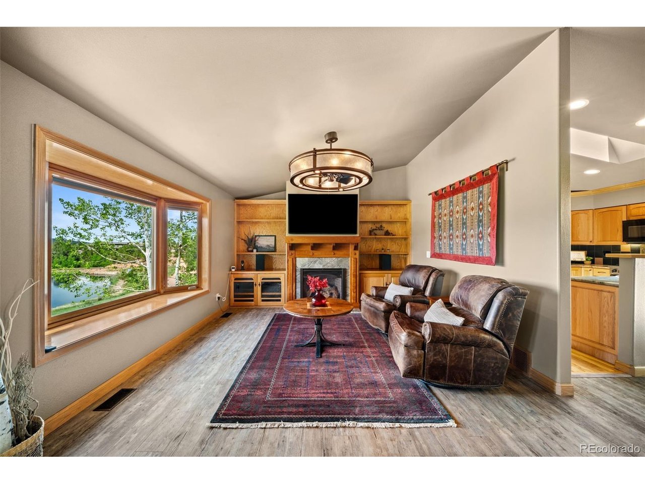 Welcome to this updated mountain retreat located just outside the city limits of Woodland Park, where short-term rentals are allowed, offering flexibility as a full-time residence, vacation getaway, or income-producing investment property. Nestled in a peaceful cul-de-sac, this home enjoys tranquil views of the community pond, where residents and guesst can enjoy fishing with a paid permit. This home features luxury vinyl plank flooring, fresh interior paint, updated lighting, stainless steel appliances, professional landscaping with retaining walls, and a concrete driveway. The main level offers a comfortable layout with a living room, dining area, and kitchen with direct access to the back deck and fenced area-perfect for pets. Enjoy outdoor entertaining and summer grilling under the motorized awning, providing shade and comfort while taking in the peaceful surroundings. Also on the main level are two bedrooms with a full bathroom, along with a primary bedroom and an ensuite complete with heated tile floors for added luxury and comfort. The walk-out lower level opens to the front yard and pond views, creating additional living and entertaining space. Here you'll find a family room, a versatile flex area ideal for a home office, craft room, or workout space, plus a laundry area with a half bath. The oversized two-car garage offers plenty of room for vehicles, outdoor gear, and storage. Conveniently located near Highway 24, this home provides easy access to Colorado Springs while placing you just minutes from the many recreational opportunities that make the Pikes Peak Region so desirable. Explore nearby lakes, rivers, parks, national forest lands, hiking trails, and endless mountain scenery. Enjoy the convenience of town amenities combined with a peaceful setting that feels worlds away. Whether you're searching for a year-round home, a seasonal mountain escape, or an investment opportunity, this versatile property offers the best of Colorado mountain living.