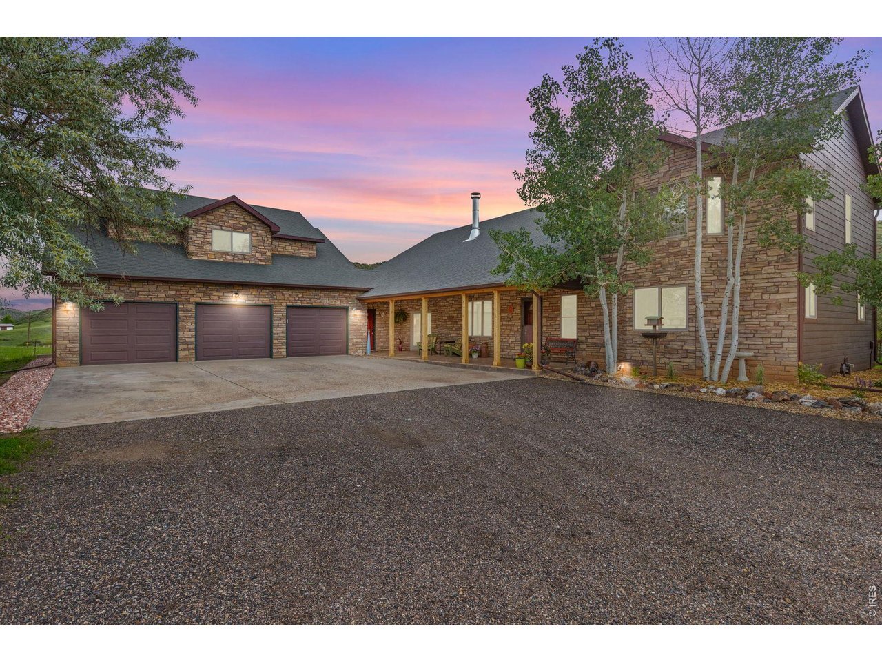 Welcome to your private Colorado retreat, perfectly positioned among the breathtaking Red Bluffs. Set on 20 expansive acres just minutes from the sparkling waters of Carter Lake, this custom-built four-bedroom, three-bath home offers a rare blend of luxury, privacy, and versatility. Step inside to an open-concept layout designed for both everyday living and effortless entertaining. Soaring ceilings and expansive picture windows flood the home with natural light, showcasing rich wood finishes, stunning views, and a hand-crafted double-sided stone fireplace that anchors the main living spaces. The gourmet kitchen is a true centerpiece, featuring stainless steel appliances, beautiful cabinetry, and ample space to gather. Whether hosting or enjoying a quiet evening at home, the seamless flow between kitchen, dining, and living areas creates a warm and inviting atmosphere. Designed with flexibility in mind, the walk-out basement offers a fully equipped private apartment with its own entrance-ideal for multigenerational living, guests, or income potential. Outdoor living shines with an oversized covered patio, perfect for entertaining or simply soaking in the peaceful surroundings and sweeping landscape. The oversized three-car garage provides plenty of room for vehicles, toys, and gear, plus an unfinished studio space above-ready for your vision. With zoning that allows for a secondary residence, this property presents endless opportunities-build a guest home, create a workshop or barn, or expand your investment potential. Whether you're searching for a serene escape, room to grow, or a home that offers unmatched flexibility, this exceptional property delivers it all-just a short drive to Estes Park and Rocky Mountain National Park.