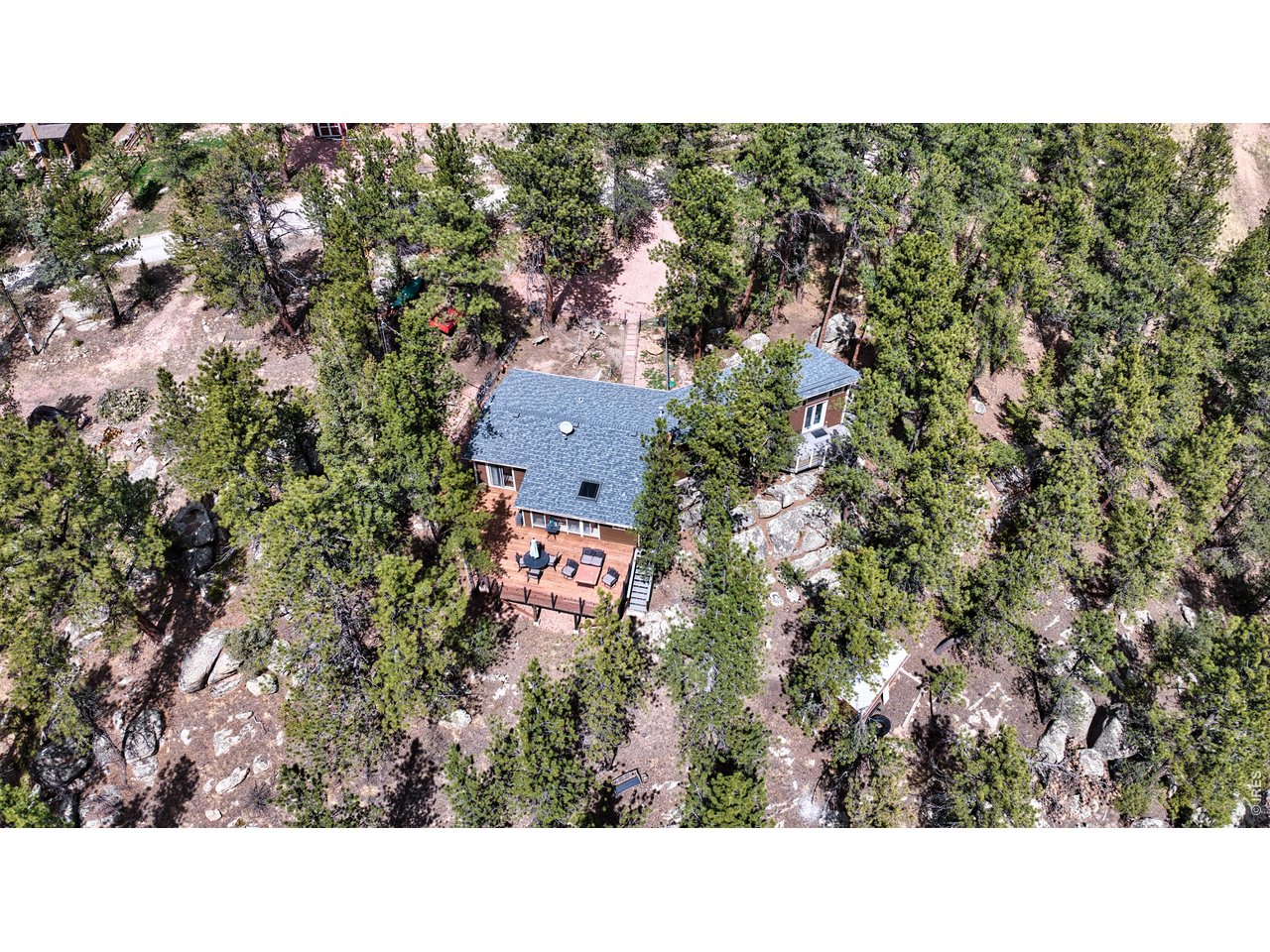 This charming 2 bedroom and 2 bathroom home in the exclusive community of Big Elk Meadows could be yours! Big Elk Meadows in Lyons, Colorado is a beautiful, gated community surrounded by Roosevelt National Forest and has many unique features and amenities. A few of these amenities include 300 acres of private hunting; access to a shooting range; stocked ponds for fishing; hiking and biking trails; a shared horse pasture with stalls; tennis and pickle ball courts; horseshoe pits; playgrounds; a heated swimming pool; and more. Additional benefits include a volunteer fire department, road maintenance, and snow removal. Conveniently located near Estes Park, Lyons, Longmont and Boulder, this home offers the perfect blend of mountain living and modern convenience. Whether relaxing in the sunroom or on one of two outdoor decks, this main-level living home is available for year-round or seasonal living. Sitting on .59 acres at the end of the road, this home sits adjacent to both an empty lot and an open space. Privacy is all-around you with only the sounds of nature to listen to and a peek-a-boo view of the lake. Rock outcroppings, trees and mountain views, and a nearby creek wrap around this beautiful home in Lyons, Colorado. Other noteworthy features include two fireplaces, an outdoor storage shed, and a fenced yard. Wildlife is abundant with moose, elk, deer and turkeys frequenting the yard and community. Don't miss your chance to own this exceptional mountain retreat!