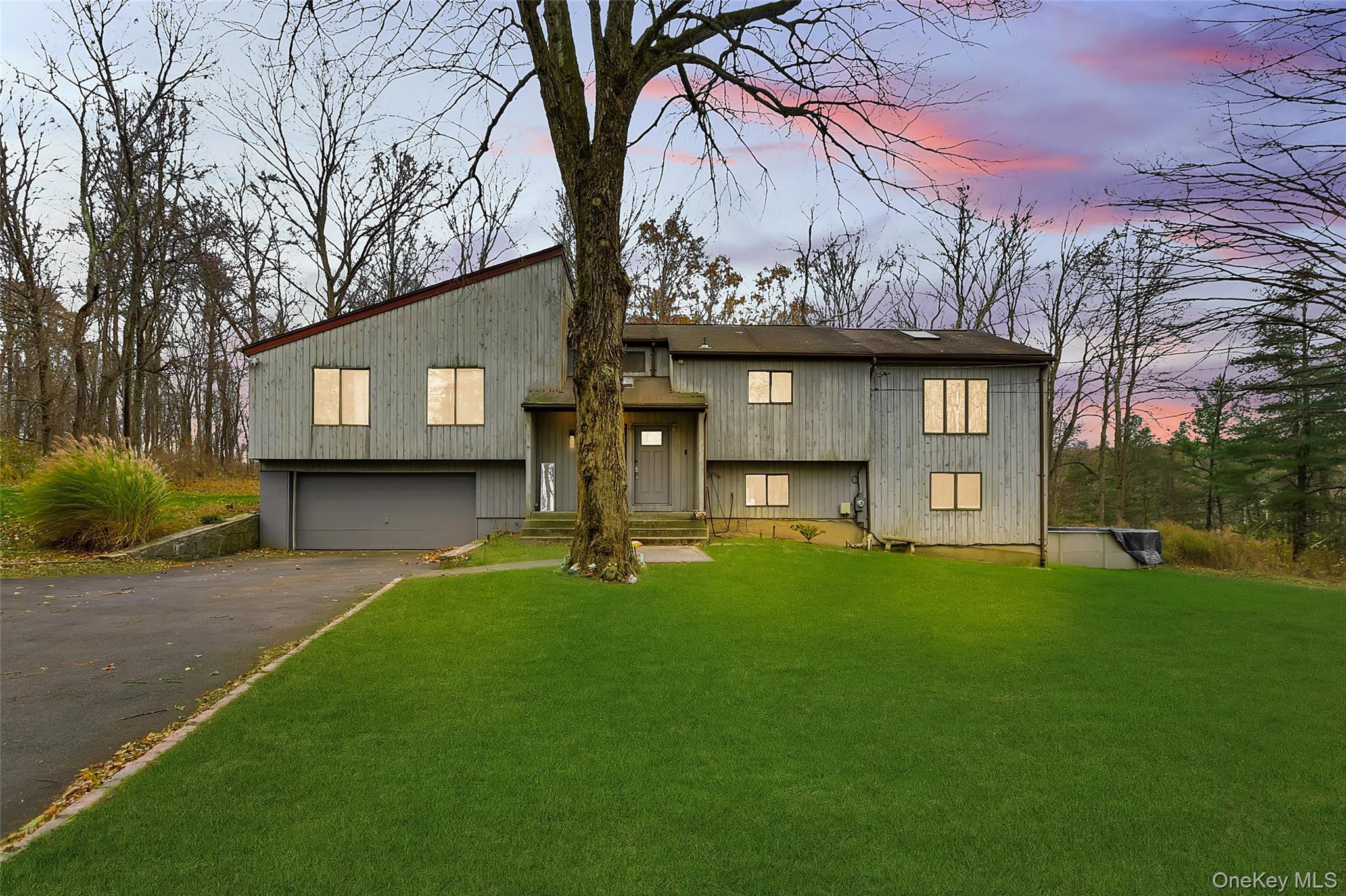 Welcome to this large 3-bedroom home located in the sought-after Yorktown School District. Set on a picturesque, park-like acre, this contemporary raised ranch offers spacious living with modern comfort and style.  The main level features a 2-story entry with a skylight, a living room with a brick fireplace, and a dining room with sliders leading to the deck. The kitchen opens through French doors to a large great room—perfect for entertaining—with additional access to the deck. The primary bedroom includes an updated full bath, while two additional bedrooms share a hall bath.  The walk-out lower level offers incredible flexibility, including a large family room with Italian porcelain tile floors, an office, and a den—ideal for use as a potential 4th and 5th bedroom. A door leads directly to the oversized heated garage.  Enjoy outdoor living with a level, private acre and a 36' above-ground pool. Additional features include vaulted ceilings, skylights, wood floors, updated baths, and a generator hook-up. Conveniently located to all - just minutes to shopping, restaurants, parkways, schools, and more.  Make your appointment to view this home now!