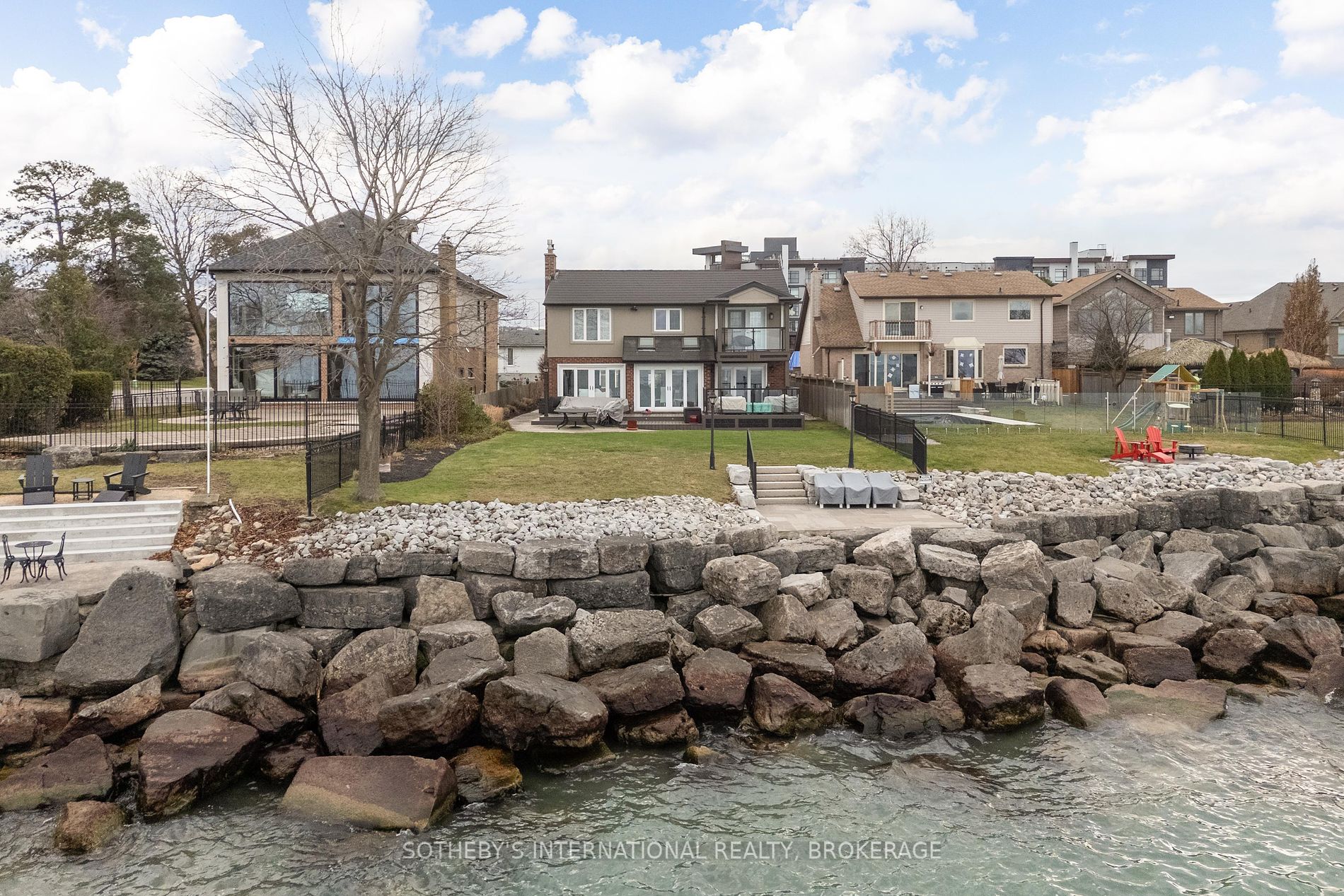 Exquisite Waterfront Retreat: Your Dream Lifestyle Awaits. Discover refined lakeside living in this fully renovated, classic-style home, a sanctuary of tranquility and understated elegance. Panoramic lake views grace the open-concept living area, where natural light dances on the high-end finishes, creating a warm and inviting ambiance. The gourmet chef's kitchen boasts top-of-the-line appliances and custom cabinetry, flowing seamlessly into the spacious living and dining areas, perfect for hosting gatherings both intimate and grand. Three bedrooms offer respite and relaxation, while three luxurious full bathrooms, adorned with premium fixtures, provide spa-like indulgence. Two gas fireplaces create warm, inviting focal points. This turn-key property showcases high-end finishes throughout, ensuring effortless elegance and low-maintenance living. An oversized 2-car garage provides ample space for vehicles and storage. Imagine waking to the gentle lapping of water and the breathtaking sunrise over the lake. Step outside and embrace an active lifestyle with 30' riparian rights, perfect for kayaking, paddleboarding, or simply enjoying the peaceful waterfront. This home offers not just a residence, but a lifestyle, a harmonious blend of serenity and recreation. Whether you envision quiet mornings sipping coffee on your deck, afternoons exploring the lake, or evenings entertaining, this property caters to your every desire. This is a rare opportunity for discerning buyers seeking luxurious, low-maintenance waterfront living. The meticulous renovation has thoughtfully preserved the home's classic charm while incorporating modern amenities. Every detail has been carefully considered, from the custom millwork to the designer lighting. Don't miss this chance to own a piece of paradise. Schedule your private showing today and experience the magic of lakeside living. This is more than just a home; it's an investment in your lifestyle, a place where memories are made.