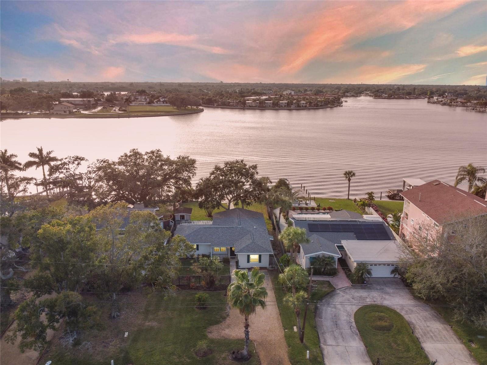 Exceptional waterfront opportunity on Smacks Bayou! Offered primarily for lot value, 3618 Shore Acres Blvd NE features a 66 x 150-foot lot, a brand-new seawall, and stunning views across the bayou toward St. Raphael’s Church. The south-facing waterfront captures beautiful morning and evening light, creating an extraordinary setting for your future dream home. Renovate the existing 3-bedroom, 1-bath block residence with newer 2018 roof or explore the possibilities for new construction to take full advantage of this outstanding location. The existing home includes a spacious covered back lanai and outdoor kitchen, ideal for enjoying the waterfront setting. With expansive water views, excellent boating access, and multiple new multimillion-dollar homes rising nearby, this property offers an exciting opportunity in one of St. Petersburg’s established waterfront neighborhoods with great boating access. Convenient to downtown St. Petersburg, shopping, dining, schools, and the Gulf beaches, this is your chance to create the waterfront lifestyle you envision.