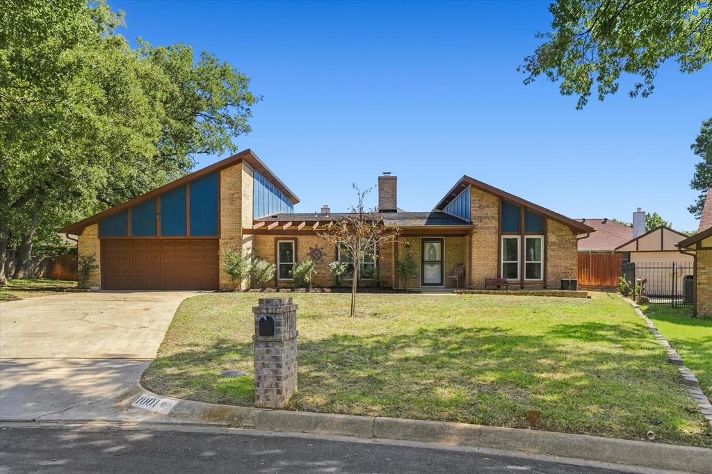 Step into this spacious contemporary ranch-style home, where vaulted, beamed ceilings, abundant natural light, custom-stained concrete flooring and a brick fireplace create a striking living room centerpiece. Walls of windows overlook a private backyard retreat featuring an inground salt water swimming pool with an 8.5-foot deep end, two covered patios and an 8-foot wood privacy fence. The stained-cedar pergola is equipped with lighting and an outdoor TV setup, while the impressive 8-by-6-foot hot tub conveys—making this home ideal for year-round entertaining. The eat-in kitchen features custom cabinetry with pullout drawers and racks, granite countertops, newer appliances, an induction cooktop and oven, microwave, dishwasher and dedicated coffee bar. The spacious 3-bedroom, 2-bath layout includes generously sized bedrooms, two primary bedroom closets and cozy carpet in the bedrooms. The primary bath offers a separate tiled and glass shower, granite vanity with vessel sink and a separate easy-entry tub. Additional features include a Daikin high-efficiency heating and cooling system featuring a compact space saving outdoor heat pump and HEPA filter, separate laundry room, full sprinkler system, large storage shed, abundant attic storage with a motorized storage lift in the 20-by-22-foot two-car garage, smart bulbs with remote control in living room. Situated on a quarter-acre cul-de-sac lot with minimal traffic in an established neighborhood. LG washer and dryer are negotiable.