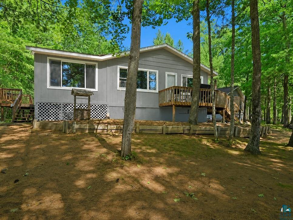 Enjoy lake life on beautiful Beauregard Lake! This updated 2-bedroom, 1-bath cabin/year round home is set on a level 2.35-acre lot with a sandy beach and an impressive 302 feet of waterfrontage. Whether you are looking for a peaceful year-round retreat, a weekend getaway, or a Northwoods basecamp, this property offers the space, setting, and amenities buyers are seeking. Inside, the cabin features a remodeled kitchen with granite countertops and updated appliances. The dining room features engineered hardwood floors and a wood fireplace for ambiance and that backup heat. The Living room features large Anderson windows facing East on Beaurgard Lake for those awesome Sunrise views. The home also offers a full basement, 200-amp electrical service, and two-zone heat for added comfort and efficiency. New roofs were completed in 2025, giving the next owner added peace of mind. The property is well-suited for storage, hobbies, guests, and outdoor living. A spacious 28x52 insulated garage includes power, a cement floor, and a 27X14 finished all-season bunk area—perfect for extra sleeping space, recreational gear, workshop use, or storage. There is also a newer 10x14 “she shed” with power and lights, an air conditioner built in 2023, plus a 10x4 lake shed near the water for convenient storage of lake toys, fishing gear, and outdoor essentials. A charming outhouse with an attached garden shed adds both character and function. Step outside and enjoy the level yard, sandy shoreline, and peaceful lake setting. Spend your days fishing, swimming, kayaking, boating, or relaxing by the water. At night, sit around the fire pit roasting marshmallows and sharing stories with family & friends. The Solon Springs area is known for year-round recreation, with thousands of nearby acres featuring ATV and snowmobile trails, hunting, fishing, and hiking, as well as access to the natural beauty of Northwest Wisconsin. This is a special property with waterfront access, garage space, and a hard-to-find recreational lifestyle. Come and see if this is the one for you!