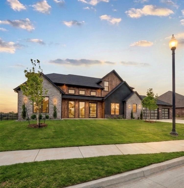 A rare waterfront residence in a private gated community, this fully furnished home showcases uninterrupted water views stretching across the entire rear of the property. Designed to maximize the scenery, every main living space is filled with natural light and seamlessly connected to the outdoors through expansive windows and first- and second-floor outdoor living areas.The striking modern exterior opens to warm, sophisticated interiors featuring hardwood floors, rich textures, moody tones, leathered and marble countertops, statement lighting, and a custom illuminated handrail. The chef's kitchen is appointed with premium graphite-finish Dacor appliances and complemented by a fully equipped scullery featuring three built-in ovens, ideal for effortless entertaining.Built with Brady Built Homes' signature craftsmanship, the home also includes spray-foam insulation, a conditioned attic, recirculating hot water system, and smart home technology for exceptional comfort and efficiency.Located in The Grand, a private lakefront community within the acclaimed Piedmont School District, residents enjoy stocked lakes, fishing, paddleboarding, canoeing, and exceptional recreational amenities. Just south of the Kilpatrick Turnpike, the location offers quick access to shopping, dining, entertainment, and downtown OKC while preserving a peaceful, waterfront setting. Modern, timeless, and designed for everyday luxury, this is lakeside living at its finest.
