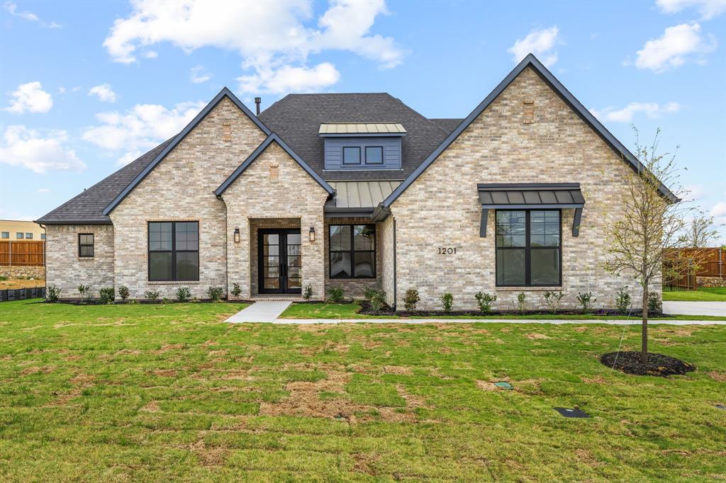 Walk to the lake from this stunning new one-story home by Olivia Clarke Homes, offering 3,840 sq ft of luxury living on a rare half-acre lot in The Arbors at Lakewood Village. This expansive 80-ft-wide floor plan is thoughtfully designed with 4 generously sized bedrooms, each featuring a private en-suite bathroom, plus a dedicated study and a spacious game room. The open-concept living area is ideal for entertaining and everyday living, anchored by a chef’s kitchen with a 48-inch built-in refrigerator and freezer, a functional morning kitchen with its own pantry, a separate pull-out pantry for additional storage, and a dedicated wine bar. Oversized windows flood the home with natural light and frame peaceful views of the private lot. The primary suite is a true retreat, featuring a spa-inspired bath with freestanding soaking tub and separate his-and-her walk-in closets. Additional highlights include abundant storage, a 3-car garage, and an oversized covered patio with outdoor fireplace—perfect for year-round enjoyment. Enjoy luxury living with NO HOA, NO MUD, and NO PID taxes.