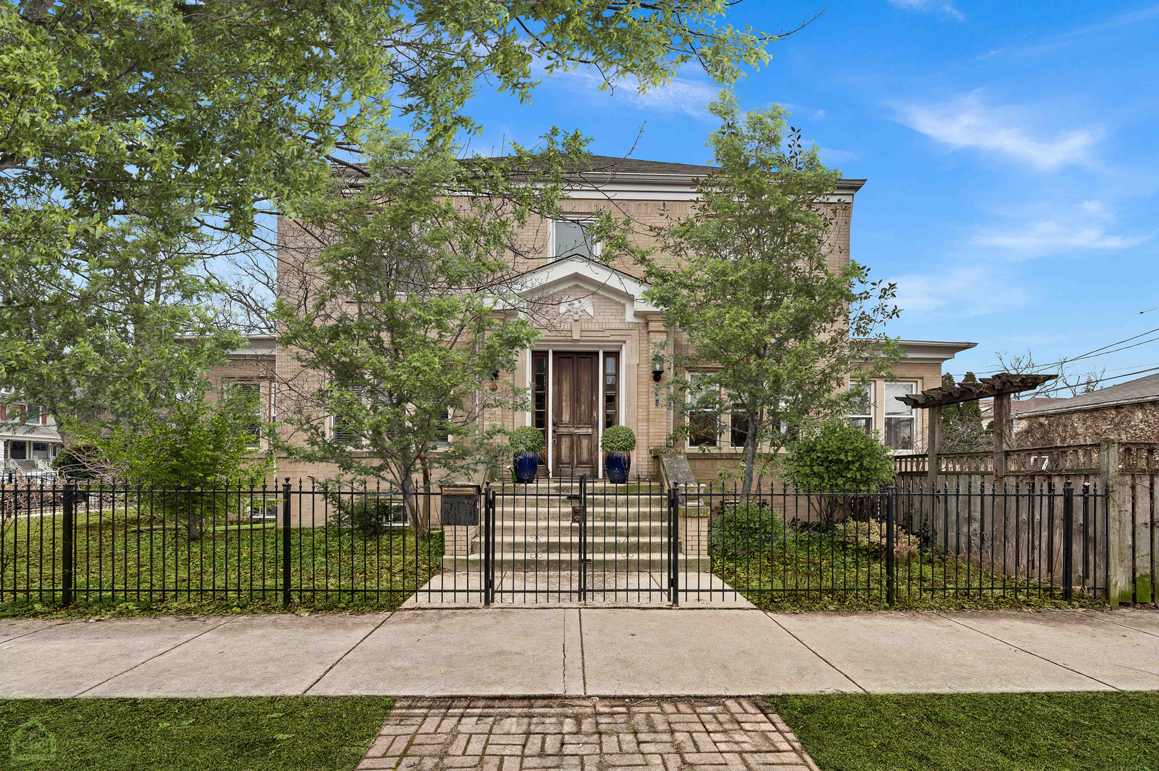 This elegant, all-brick 5-bedroom residence with 3 full and 1 half baths sits on an oversized double wide corner lot in the sought-after Ravenswood Manor neighborhood, within the well-respected Waters School District. Boasting a picturesque facade, the home welcomes you with a grand foyer overlooking the original staircase, setting the tone for the refined interior. The spacious living room, adorned with abundant windows and a striking stone fireplace, flows seamlessly into a sunlit reading nook or office space. The heart of the home, the updated eat-in kitchen, features custom white cabinetry complemented by white subway tile and sleek black quartz countertops. Equipped with top-of-the-line appliances, including a SubZero refrigerator, six-burner Wolf oven, and built-in Miele coffee maker, as well as an expansive island with breakfast bar seating, the kitchen is ideal for both casual dining and entertaining. Expanding the living space outdoors, the kitchen opens onto a deck, gated yard, and 2-car garage and parking pad. Upstairs, the upper-level houses four generously sized bedrooms, including a luxurious primary suite complete with an original ornate chandelier, a large walk-in closet, and a spa-inspired bathroom featuring Carrera marble and a spacious glass-mosaic shower. The lower level offers additional living space with a vast recreation room perfect for hosting gatherings or accommodating guests as an in-law suite. Completing the lower level are a bedroom, full bath, storage room,  mechanicals, and laundry facilities. Conveniently situated near the Francisco Brown Line station, Horner Park, and an array of shopping and dining options along Montrose, Lawrence, and Kedzie, this unique home also provides easy access to the Kennedy Expressway.